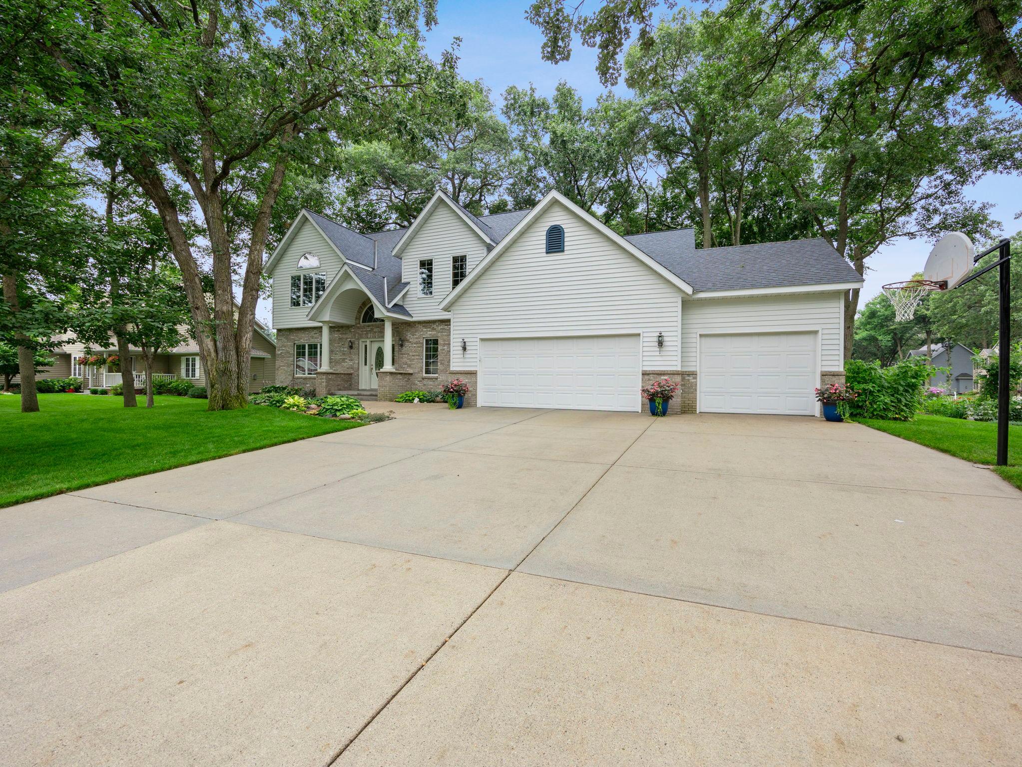 Welcome to this five-bedroom, four-bathroom, two-story home on a large corner lot in Sartell, near Morning Star and Northside Parks, with easy access to trails, shopping, and dining along the Mississippi River.The main level features 9-foot ceilings, oak floors and six panel oak doors throughout, and a kitchen with stainless steel appliances, tile backsplash, and walk-in pantry. Also included are a living room with fireplace, a formal dining room with tray ceiling, a sitting room, a laundry room with built-in cabinets, a half bath, and a heated three-car garage with epoxy flooring and EV charging.Upstairs offers a primary suite with vaulted ceiling, granite en suite, soaking tub, and walk-in shower and closet, plus three more bedrooms, two with walk-in closets and a shared full bath.The lower level includes a library room with built-in bookcases, a family/rec room with gas fireplace and lookout windows, a fifth bedroom with walk-in closet, a three-quarter bath, and storage.Enjoy a private backyard patio surrounded by mature trees. Recent updates include a new roof (2020), furnace/AC (2021), water softener (2022), garage heater/insulation (2022), EV charger (2023), and whole-house carpet (2025).