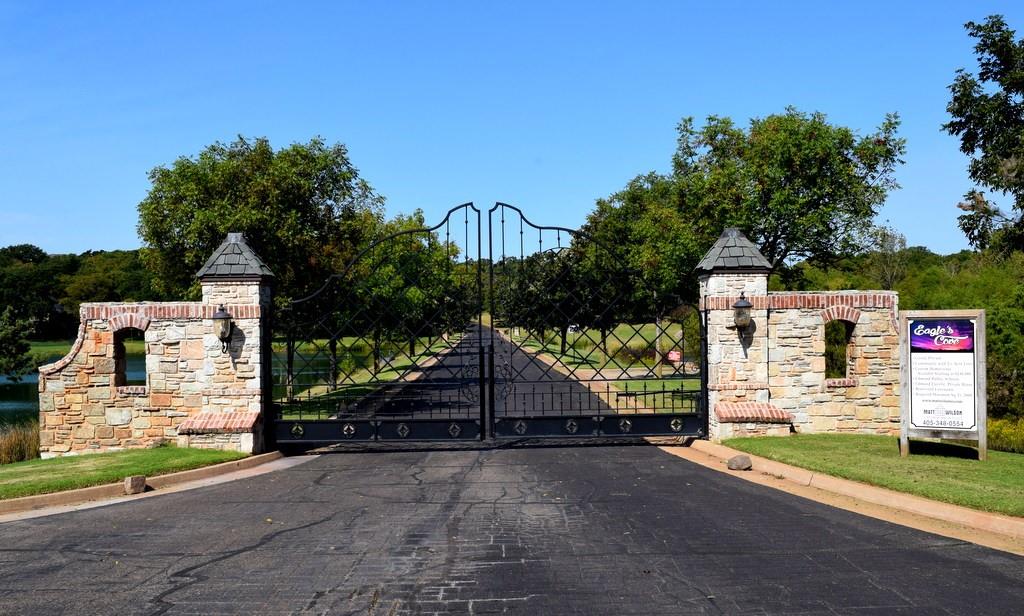 Welcome to the Eagles Cove Addition, an east Edmond development nestled among the trees and backs up to Arcadia Lake. This gated neighborhood is just a few miles from I-35, making commuting and accessibility to shopping in Edmond and North Oklahoma City, extremely convenient. This heavily wooded lot is the second lot on the street nestled between two gorgeous homes.