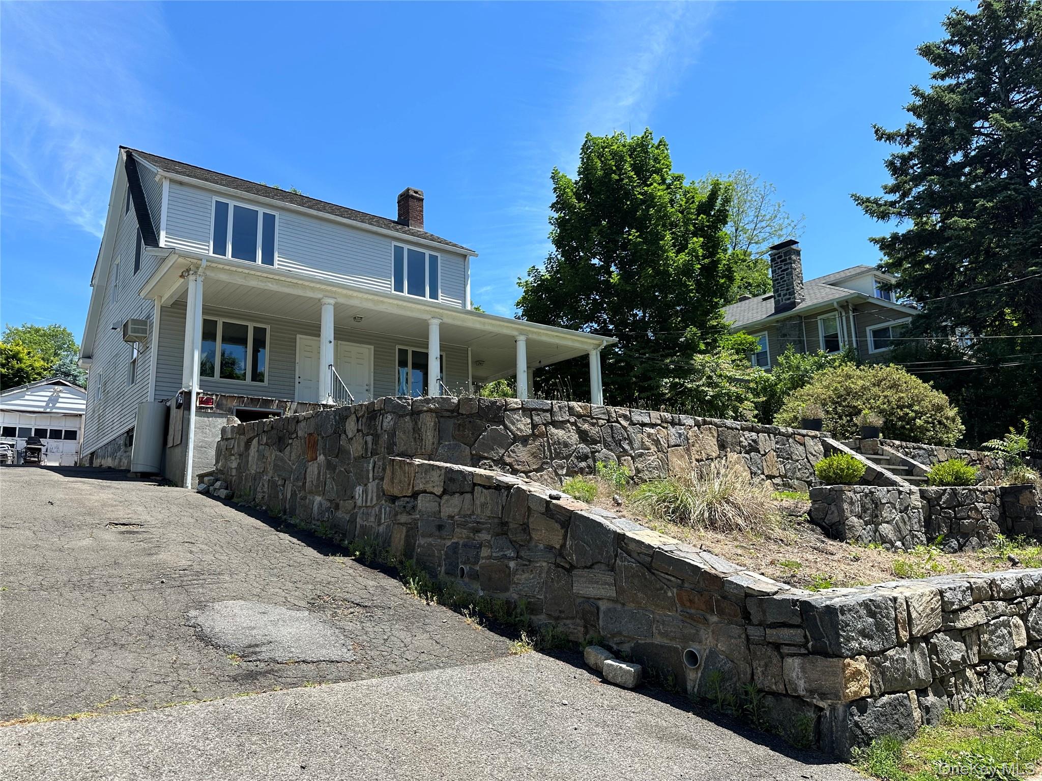 Prime Opportunity in highly regarded Area!  Perfect Opportunity to renovate your dream home in one of the more sought-after communities, renowned for top tier schools and exceptional neighborhood charm.  This single family residence sits on a slightly elevated lot offering added appeal and distinction.  See beautifully formed landscaped grounds featuring stone entrance design and tasteful lighting.  Enjoy the charm of  wrap around porch perfect for front and side views while still giving a feel of privacy.  Inside the home invites you with front and double sided entrance and exposure.  The living room with large brick fireplace.  The kitchen presents tremendous opportunity with a layout for relaxation, dining, family gathering.  Sunroom room overooks backyard.  Spacious bedrooms with skylight on 2nd.   Additional highlights include long driveway and garage providing convenience and ample parking.  It is an amazing opportunity to blend your vision and and be in the location of your desire.  This Dobbs Ferry gem affords the best of suburban living with convenience of nearby shops, dining, and scenic Hudson River area!