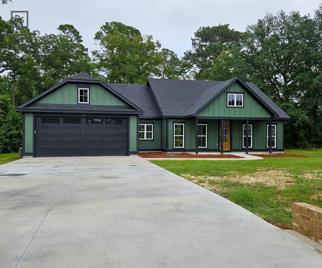 Another stunning new build in sought-after Sweetwater Subdivision! T situated on a 1.08 acre lot! This thoughtfully designed home offers a split and open floor plan, blending  Step into the spacious living room, highlighted by soaring vaulted beam ceilings and an inset electric fireplace wrapped in shiplap with a beautiful natural wood mantel. A separate dining area features recessed lighting and a striking tray ceiling detail—perfect for entertaining. The kitchen overlooks the living area and boasts a granite-topped island with bar seating, storage, pendant lighting, and a convenient outlet. Stainless steel appliances—including refrigerator, dishwasher, stove, and microwave—pair perfectly with the subway tile backsplash. Over- and under-cabinet lighting, a corner display cabinet, and a walk-in pantry with custom wood shelving (behind an oak-stained barn door) complete the space. The pantry also has room for a second refrigerator or deep freezer. Just off the kitchen, a garage-entry foyer with a bench and shoe storage leads to a spacious laundry room with cabinetry and a utility sink—making everyday tasks simple and organized.  The roomy primary suite features a tray ceiling with recessed lighting and a custom walk-in closet. The luxurious primary bath includes dual granite-topped vanities separated by a custom storage divider, a private toilet room, and a beautifully tiled shower with wall and rain shower heads plus a built-in bench. Guest Bedrooms & Bath On the opposite side of the home, two generously sized guest bedrooms feature custom closet built ins. The guest bath is equally spacious with a granite vanity and ceramic tiled tub/shower combo.   Enjoy an oversized covered back porch with an extended deck, perfect for gatherings or quiet evenings, overlooking a large backyard. Throughout the home you will find durable LVP flooring, recessed lighting & ceiling fans, ample electrical outlets & natural light, matte black fixtures with white and oak accents for a modern, timeless feel,  lighted closets and thoughtful attention to detail throughout.  This home is the perfect combination of style, function, and craftsmanship. his home beautifully blends style, functionality, and quality craftsmanship. Schedule your showing today and see the difference for yourself!