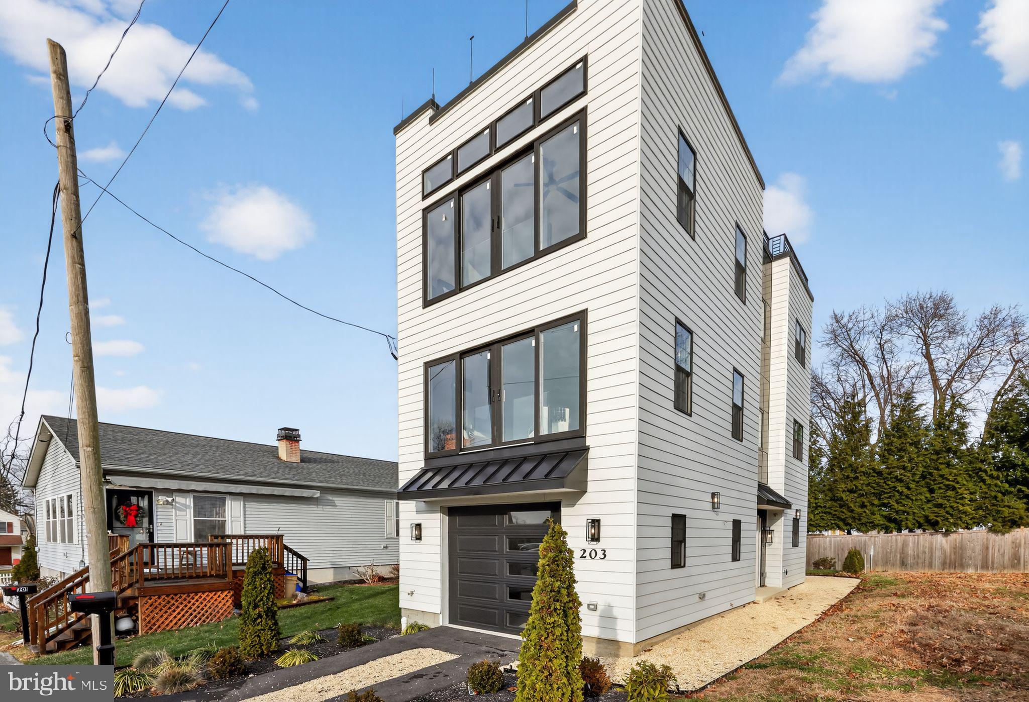 Experience modern luxury in this exceptional new 4-bedroom, 3-bath home overlooking Odorsio Park in Wayne. The versatile first level features a private side entry, garage access, and a flexible guest space perfect for an office or extra bedroom with access to the rear patio.The light-filled second level impresses with an open-concept living area and a stunning chef’s kitchen complete with a quartz waterfall island, premium Z-line appliances, built-in coffee machine, custom 42" cabinets, and pot filler.Upstairs, you'll find a spacious guest bedroom, convenient laundry, and a beautifully finished hall bath. The primary suite offers abundant natural light, park views, and a spa-inspired bathroom. Continue up to the full roof deck for sweeping views—ideal for sunsets and entertaining.The finished basement adds a fourth bedroom with egress, a wet bar, generous storage, and a full bath. All just steps from trails, dining, top local schools, and regional rail. Don’t miss this one-of-a-kind home!