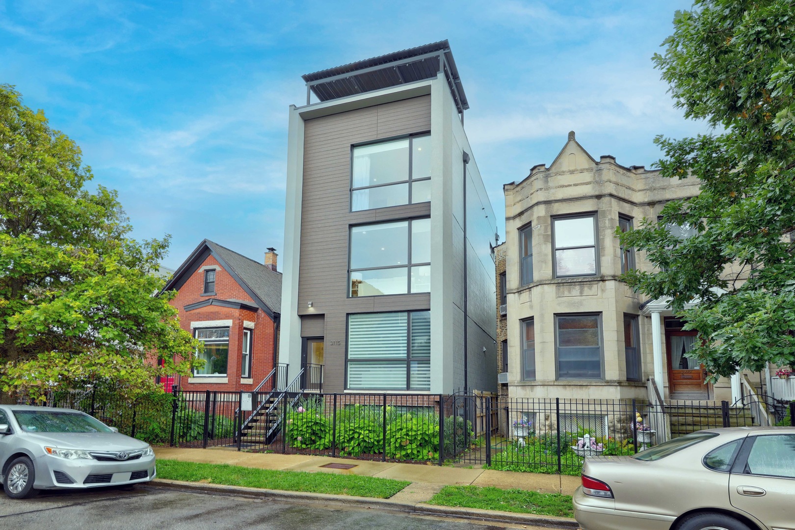 3115 W Lyndale - Logan Square Duplex Up Penthouse. Step into style and sophistication with this 3 bedroom / 3 bath duplex-up penthouse in an intimate two-unit building on one of Logan Square's most desirable tree-lined streets. Walls of oversized, floor-to-ceiling windows flood the home with natural light, highlighting custom contemporary cabinetry, quartz countertops, Bosch appliances, under-cabinet lighting, and wide-plank oak hardwood floors. Interior details include 8' solid-core doors, designer fixtures, and a split-level layout with a top-floor primary suite offering spa-like luxury: heated floors, steam + rain shower, and fully built-out closets.    Modern living continues with pre-wiring for a full tech package-including speakers, video intercom, and security system. Outdoor space is a dream, featuring multiple decks, an interior stair to your private rooftop oasis, and an additional rear deck. Garage parking included. Prime Logan Square Location -- Live in the heart of Chicago's most celebrated food neighborhood (Axios #1 pick). Just blocks from culinary icons like Lula Cafe, the award-winning Daisies, the legendary Longman & Eagle, inventive newcomers like Akahoshi Ramen and The Duplex, plus neighborhood favorites like Bang Bang Pie and Bungalow by Middle Brow. Palmer Square Park is at your doorstep, and the CTA Blue Line puts downtown and O'Hare within easy reach. This is not just a home-it's the perfect blend of contemporary design and Logan Square lifestyle.
