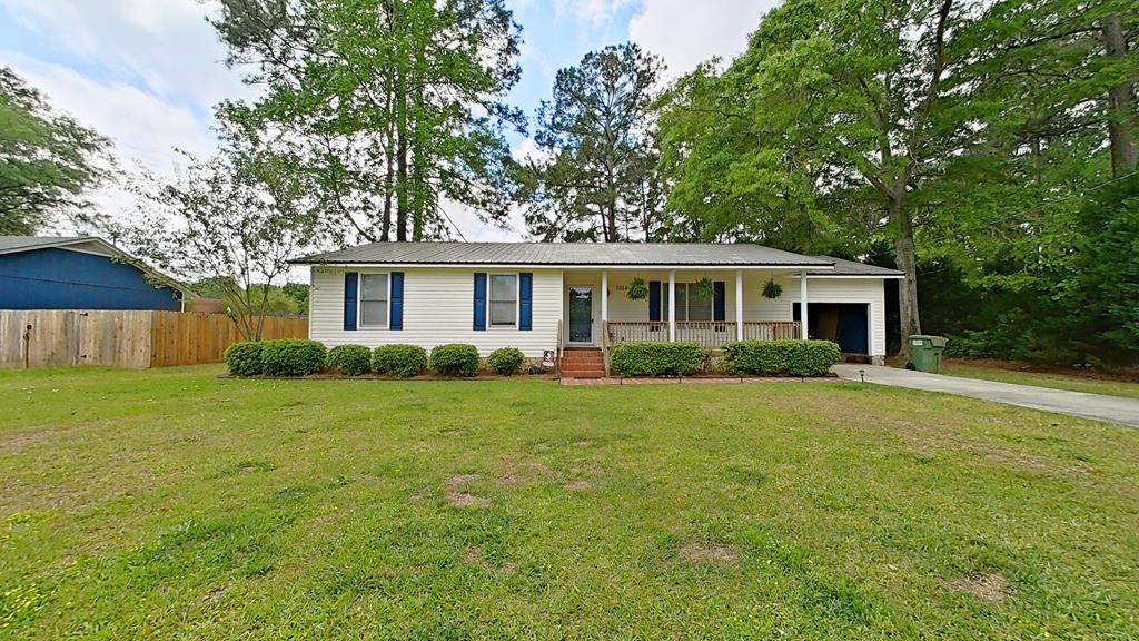 Beautiful three-bedroom, two-bathroom home that's been completely remodeled, featuring a fully fenced yard, shed, covered deck, and a rocking-chair front porch. Kitchen showcases a breakfast bar, stainless steel appliances, and opens to a separate dining room. Large primary suite includes a spacious bathroom with a walk-in shower, tile floors, and his-and-hers closets. Two additional nicely size bedrooms and a remodeled second bathroom. Walk-in full-sized laundry. French doors open to the covered deck and a generous backyard, perfect for entertaining. Outdoor area is beautifully landscaped with brick paver walkway. Single car garage.