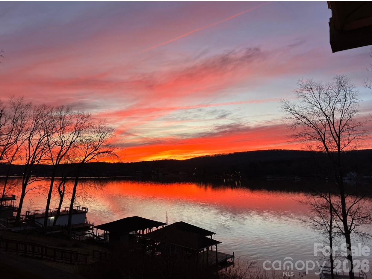 This charming 3 bedroom, 2 bathroom home in the desirable Woodrun community offers an open concept layout with vaulted ceilings, connecting the living, dinning, and kitchen areas; ideal for everyday living and entertaining. Recent updates include new ceiling fans and kitchen lighting. The main level features a primary suite with walk-in closet and bath, two additional bedrooms with spacious closets, and a full bath. The basement includes a single-car garage, laundry, and flexible storage or recreation space. Pull down attic access provides additional storage. Designed for comfort and practicality, the home includes two wood-burning stove connections for added warmth and backup power options. Situated on a sloped lot with private waterfront access to Lake Tillery, the property offers serene views, ample parking, and mature landscaping. Enjoy Woodrun's amenities, including a pool, courts, trails, boat launch while being just minutes from Albemarle, NC. Home is being sold AS-IS.