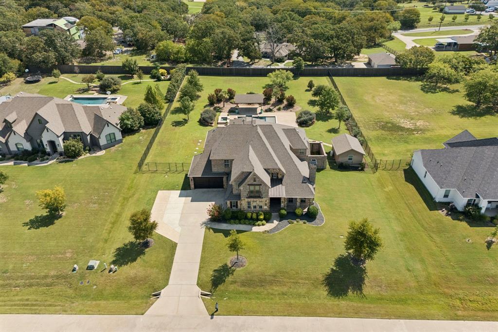 Incredible opportunity to own a one of a kind home, situated on a stunning 1+ acre lot. Located in the exclusive luxury community of High Meadows, with just 20 lots that give private access to a conservation area, you will love driving home to this peaceful place! Built in 2016, this home feels fresh and modern, offering 5 bedrooms, 6 bathrooms, an office, multiple living spaces, finished attic storage, a separate workshop, and a rare four-car garage. The owners created an outdoor paradise beginning with the screened-in porch, complete with built-in grill, sink, refrigerator, warming drawers, and new flooring for year-round entertaining. A custom pool and spa built in 2020, oversized cabana with fountain, and professional landscaping—including palm trees, magnolias, and oaks—create a true retreat. Additional highlights include a 300 sq. ft. insulated workshop with HVAC and 110 & 220V power, a whole-house Generac generator, plantation shutters, Nest thermostats, LED lighting, and a new roof installed in 2023. Inside, a spacious office retreat greets you with a fireplace sitting area and custom bookcases. A wine storage vault behind a wrought iron gate sits beneath the modernized staircase. The rotunda-style entry to the primary suite opens to an oversized retreat with dual closets, marble flooring, rain shower, Brizo fixtures, and elegant finishes. The kitchen opens to the family room and features an expansive island, granite counters, refinished cabinetry, under-cabinet lighting, and commercial-grade Thermador and Miele appliances. A downstairs flex room with ensuite bath functions as a guest suite, fitness room or 2nd office. Upstairs offers a large living area with built-in desk, a media room with kitchenette, three bedrooms with 3 bathrooms, and a finished walkout storage room. With more than $500,000 in upgrades, this home combines thoughtful design, luxury amenities, and outdoor living that makes you never want to leave.