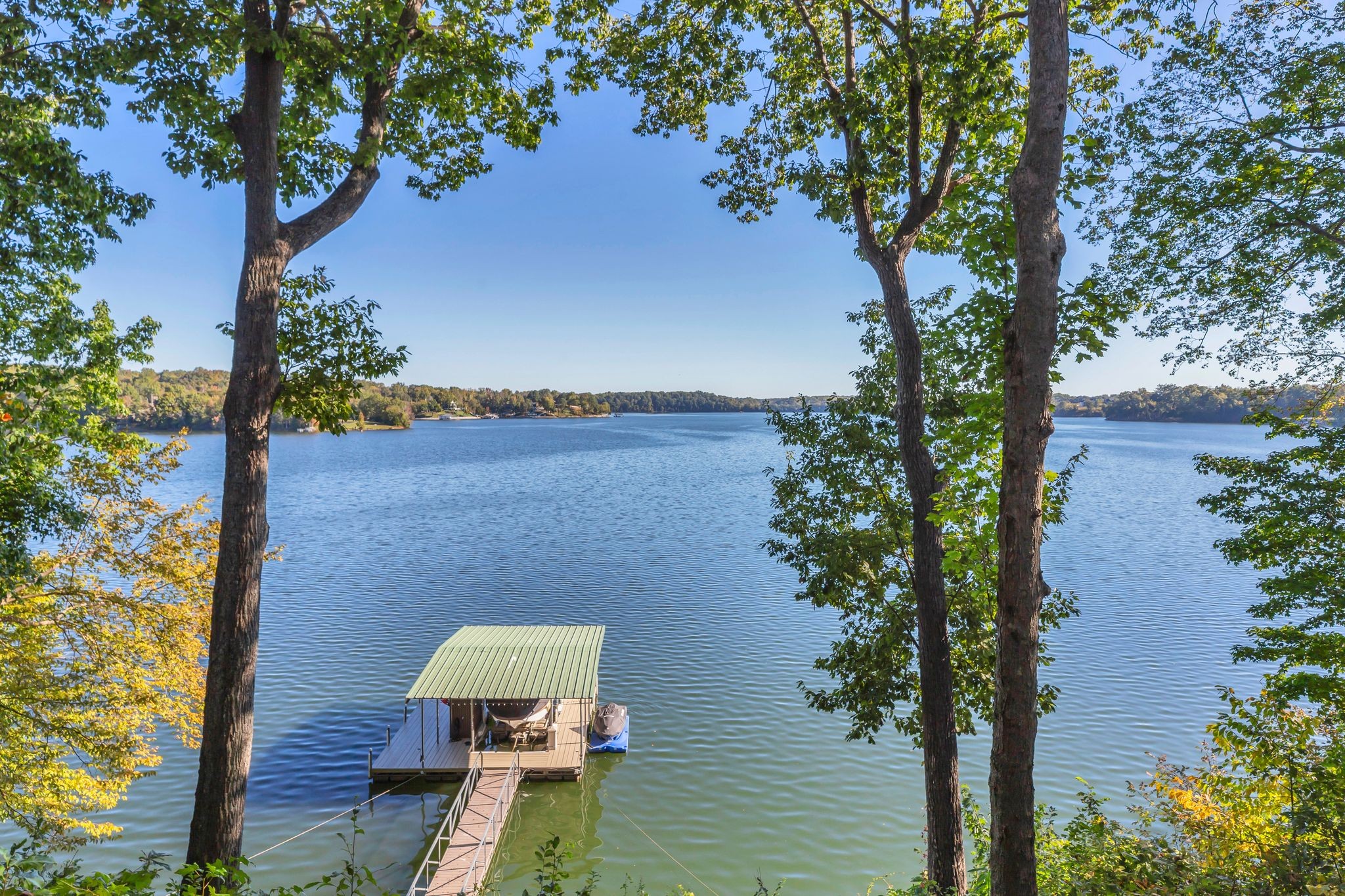 Beautiful home in Hopkins Point Sub. - Div. Lots of glass for breathtaking views of Tims Ford Lake. Year-round water, w/covered dock on property. This home offers stone entrance w/space for entertaining, top of the line appliances in kitchen w/lots of cabinet space. Wood, tile, carpet floors thru out the home. Living room w/wood burning fireplace, 4BR's/3BA's, 2 car-garage. Screen in back porch & deck for setting and enjoying the views. Downstairs a large rec room for entertaining/game room.