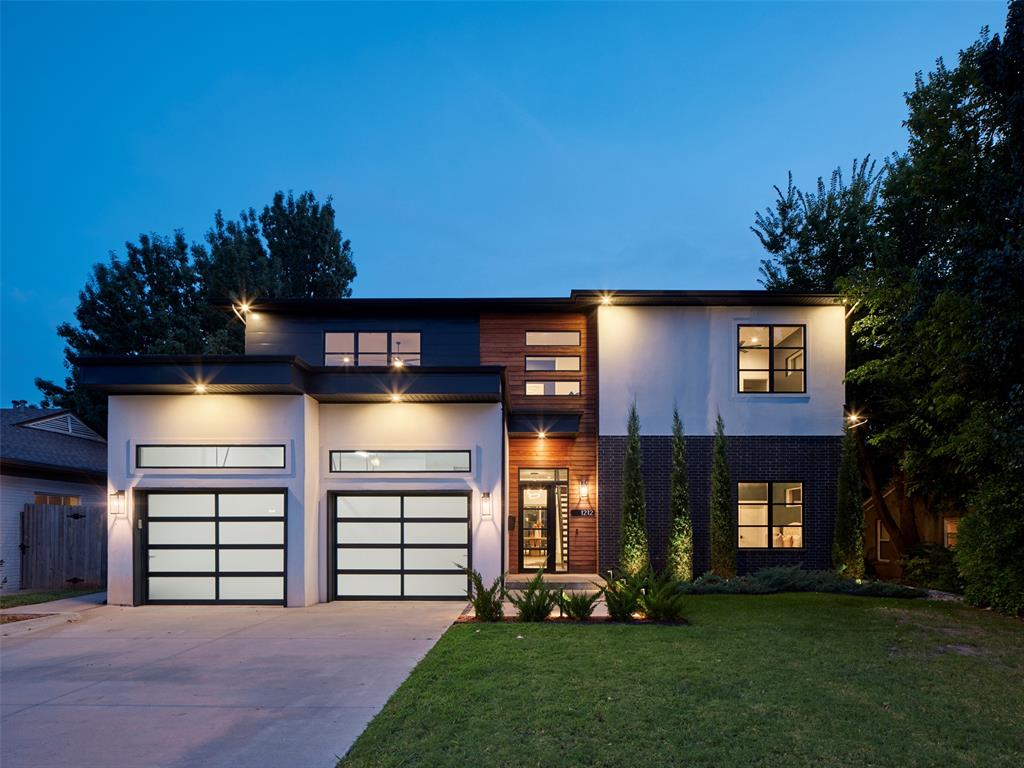 Sleek architectural lines & warm natural materials define this striking home, where stucco & brick meet rich Ipe Brazilian wood accents & glass-paneled garage doors on a 3-car tandem garage. Beautiful landscaping frames the facade & sets the stage for what lies beyond. At dusk, subtle exterior lighting & sunset reflections create an unforgettable welcome. Step through the entry to soaring ceilings & a floating open-riser staircase. Across the room, walls of Pella windows flood the interiors with natural light & frame picturesque views of the outdoor living space. The great room & dining area flow into a dramatic chef’s kitchen anchored by an eat-in island w/double sinks. Outfitted with Thermador 48" range, full-size refrigerator & freezer, wine cooler & generous custom cabinetry, the space is both high-performing & visually stunning. A massive butler’s pantry with floor-to-ceiling storage & open shelving provides abundant space for culinary essentials and entertaining. Upstairs, the luxurious primary suite is a sanctuary wrapped in natural light & moody tones, offering a spa-like bath with freestanding soaking tub & walk-through shower with triple showerheads. A custom walk-in closet & adjoining laundry room add everyday convenience. Spacious secondary bedrooms & flexible landing spaces complete the upper level. Downstairs, the main level also features a large mudroom, complete with dog wash station, as well as another bedroom & full bath; this flexible space is perfectly suited for a guest suite, office, or secondary living room. Through expansive sliding doors, the backyard becomes an extension of the interior, beckoning the outdoors in. The covered patio, with Ipe Brazilian wood ceiling, features a built-in fireplace & a fully equipped outdoor kitchen with gas grill & refrigerator. Carefully curated to balance modern sophistication & natural warmth, this home is as comfortable as it is captivating...from sunrise to starlight. Schedule your private showing today!
