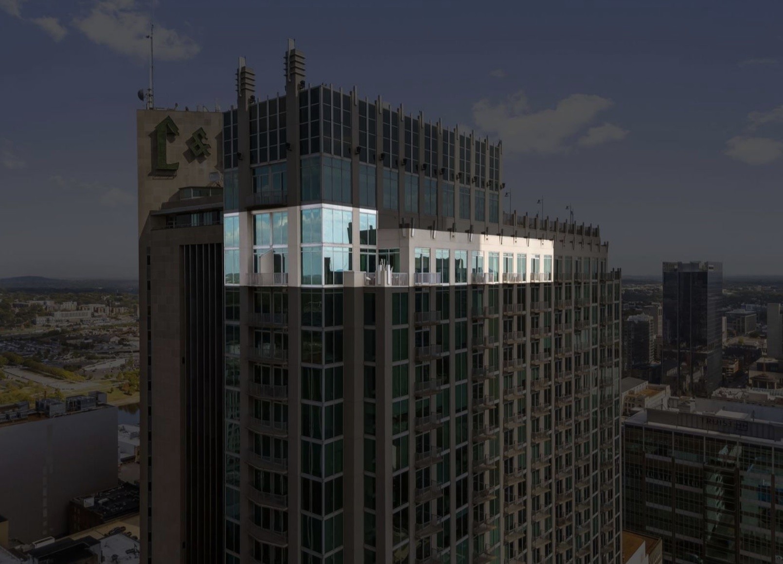 Experience the pinnacle of urban luxury in this extraordinary two-level, 30th-floor Grand Penthouse at The Viridian, a residence unlike anything Nashville has seen. Designed by Scott Wilson Architecture, interiors by Cherie Grisham, buildout by Huseby Homes, this architectural masterpiece spans 7,600+ sq ft, offering 3 beds, 3 full baths, 3 half baths with refined elegance & craftsmanship.Floor-to-ceiling windows frame sweeping skyline views, while 8 private balconies create seamless indoor/outdoor living. The grand foyer, with a 20-ft reflection ceiling & a staircase inspired by a JP Morgan staircase, features marble mosaics & curated millwork, an introduction to a home designed for elegant living & entertaining.At its heart, the chef’s kitchen by Cumberland Architectural Millwork features Wolf/Sub-Zero appliances, dual dishwashers & full butler’s pantry. An illuminated onyx bar & imported Italian marble set timeless sophistication.The primary suite offers a spa bath & dual walk-in closets, incl a remarkable 3-story custom wardrobe. 2 offices + private conference room provide productivity & privacy.Additional details: walnut doors/millwork by Julian & Sons, designer lighting, custom ceilings, Lutron shades, chilled water system, dehumidifiers & ample storage incl attic + private cage.Includes 7 garage spaces, a rarity downtown. Option to purchase adjacent 2-bed Jr Penthouse with 3 more parking spaces, ideal for guests, staff or expansion.Amenities: rooftop pool, fitness center & clubroom with skyline views.Located 2 blocks from Broadway, 1 from Printer’s Alley, 3 from Cumberland River, offering vibrant city living with privacy.The Grand Penthouse at Viridian is more than a residence, it’s a landmark. Regal & rare, it defines Nashville luxury.