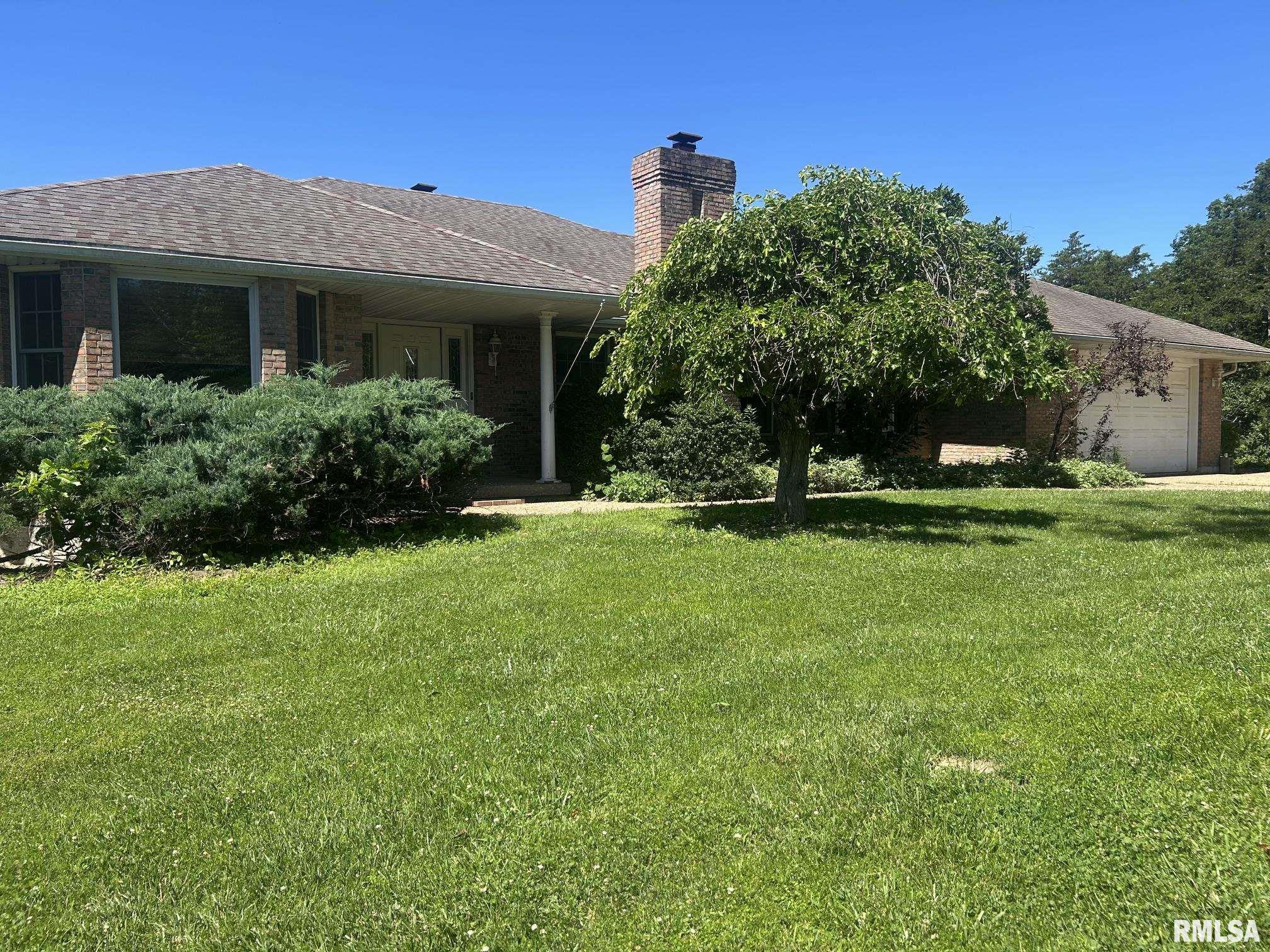 Experience exceptional space, comfort, & craftsmanship in this solid brick ranch offering nearly 6,000 sq ft of living space on a beautifully wooded 4.24-acre setting. This remarkable home provides room for everyone with 5 bedrooms, 3.5 baths, & 4 fireplaces, along with a floor plan designed for both everyday living and elegant entertaining. The main level features a formal living room, formal dining room, and a spacious great room, each offering warm, inviting gathering spaces. The kitchen is a standout with rich cherry cabinetry, abundant storage, and a convenient pantry. A main-floor laundry adds everyday ease. Retreat to the luxurious master suite, complete with a two-sided fireplace, large walk-in closet, and a spa-like bath designed for relaxation. Step directly onto the expansive full-length deck, where peaceful views of the wooded acreage create a private sanctuary.  The fully finished walkout lower level nearly doubles your living space. Enjoy a large family room with a wet bar, a second family room with another fireplace, and direct access to the secluded backyard. Two additional bedrooms feature cedar-lined walk-in closets, and there is abundant storage throughout. DIY enthusiasts will appreciate the impressive 31' x 14' workshop perfect for projects, hobbies, and easy equipment access. A rare combination of size, quality, and privacy, this home offers a great floor plan, exceptional amenities, and room to live, work, and play. Home does need some TLC price reflex
