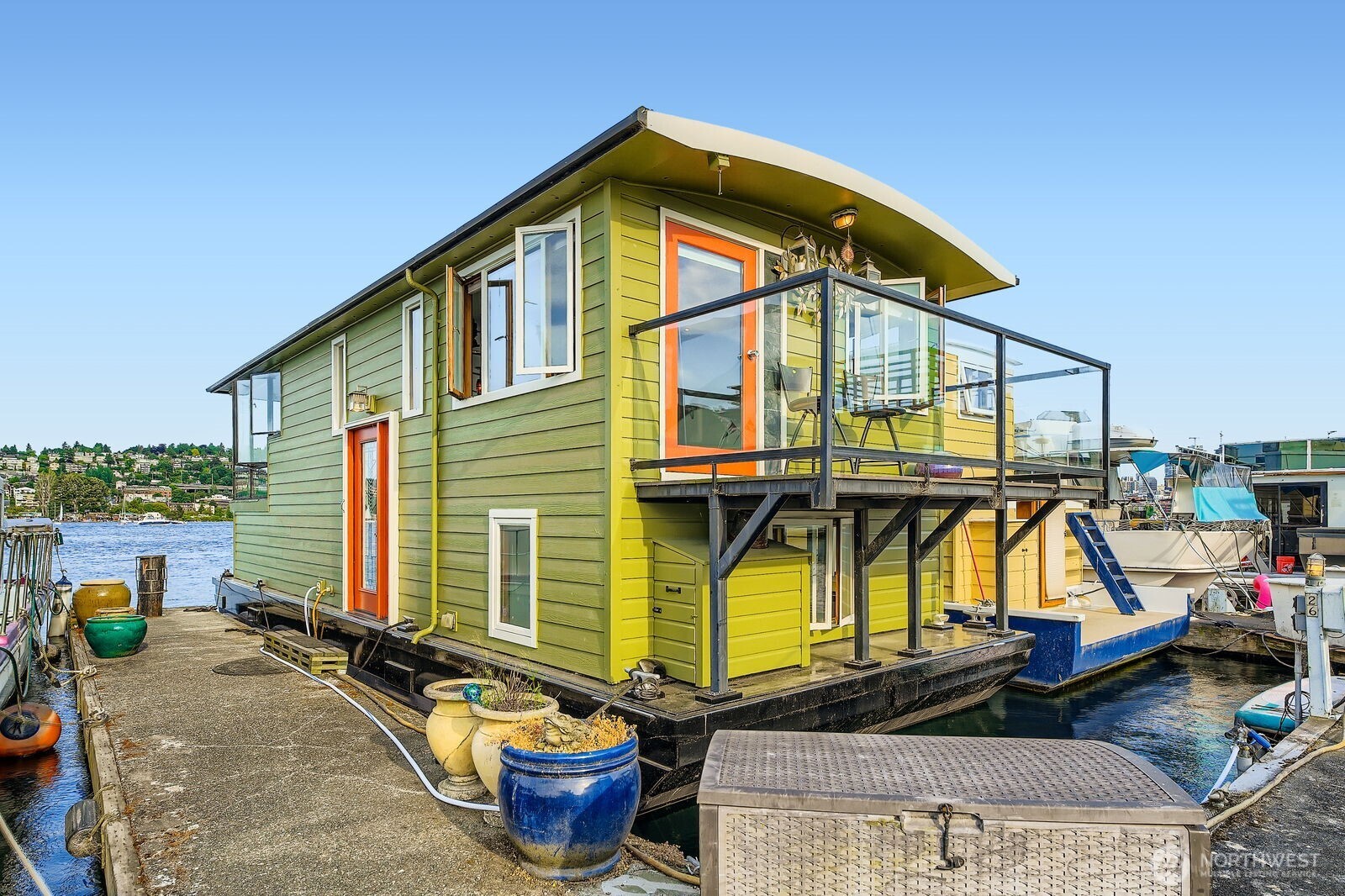 Welcome aboard this stunning 2-bedroom Seattle Houseboat ~ one of Seattle's original City Registered Housebarges.  Located on a desirable outer deck with a leased slip and incredible, unobstructed Lake Union views.  Upper level features grand artistic pillars, a wall of windows, open concept living , kitchen with granite counters, & beautifully refinished floors.  Relax on the water and enjoy stunning sunrises, seasonal fireworks, boating, kayaking, & peaceful nights.  Minutes to Google, Adobe, Amazon, Fremont Market, dining, transit, & light rail.  Hauled out & pre-inspected in June 2025.  Moorage includes utilities for $1,250/mo.  Financing available.  RPZ off-street parking included.  Pets OK.  Come & enjoy life on the water!