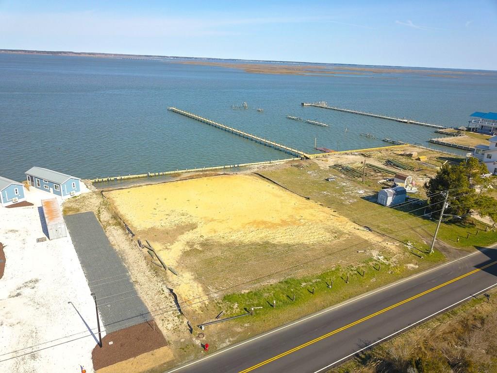 PRIME WATERFRONT on The Chincoteague Channel. Said to be "One of the highest lots on the Island". Great Location Near the Ocean. AMAZING SUNSETS! Over a Half Acre -Four Bedroom Septic Approved! Potential to subdivide. MULTI USE with C4 zoning! over $40,000  worth of permitted Sand Filled and Packed!  Build your Dream Home and Business here! *Potential to possibly subdivide.