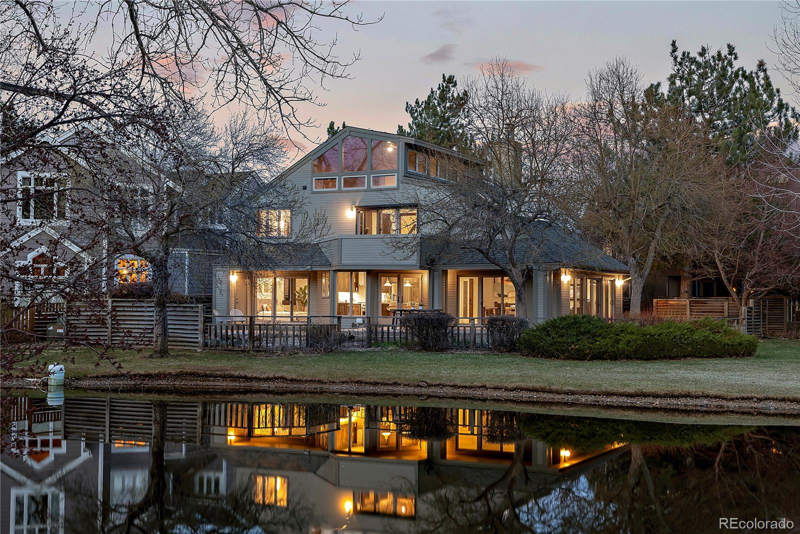 Enjoy exceptional waterfront living from one of Meadow Glen's most coveted homesites. Perfectly positioned on the original builder's premier lot, this beautifully renovated 5-bedroom, 3-bath residence offers unmatched privacy, abundant wildlife, and serene views overlooking the largest of the neighborhood's nine ponds. Seasonal Flatirons views provide a picturesque backdrop during the fall and winter months.Surrounded by trails, parks, open space, and Flatirons Golf Course, the home offers a rare combination of tranquility and convenience. Walk to Meadow Glen Park and Friends School, bike to Eisenhower Elementary, and enjoy shopping, dining, and coffee shops just minutes away.Completely reimagined in 2021-2022, the home showcases luxury finishes, smart-home features, and hardwood flooring throughout. The oversized two-car garage is EV-ready and the extended driveway provides additional guest parking.Designed for effortless indoor-outdoor living, the light-filled main level features vaulted ceilings, open gathering spaces, and two flexible bedrooms ideal for guests, a home office, or main-level primary suite.Upstairs, the primary retreat overlooks the pond and includes a private deck and lofted sitting area. Two additional bedrooms, a shared bath, laundry room, and reading nook complete the second level.The third-floor flex space offers endless possibilities as a studio, office, gym, or playroom, with built-in storage and elevated views of the pond and surrounding landscape.A rare opportunity to own one of Meadow Glen's premier waterfront properties in an unbeatable Boulder location.