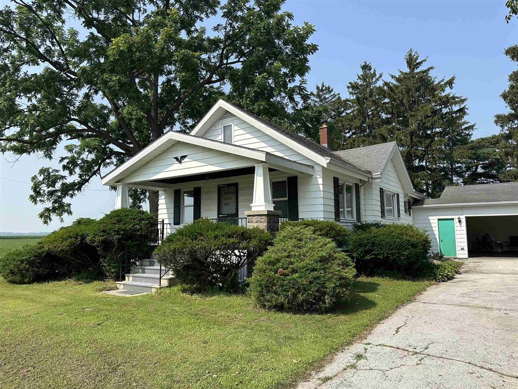 This two bedroom, one bathroom home is part of over 18 acres of property for sale. The non farmed land around the home is 4 acres, the rest of the property is tilled and tiled land currently growing soybeans. The farm land is currently leased. Two bedrooms could be turned into three by converting the laundry room into a third bedroom. Attached two car garage for personal vehicles and a work shed with two separate garage doors for farm equipment.