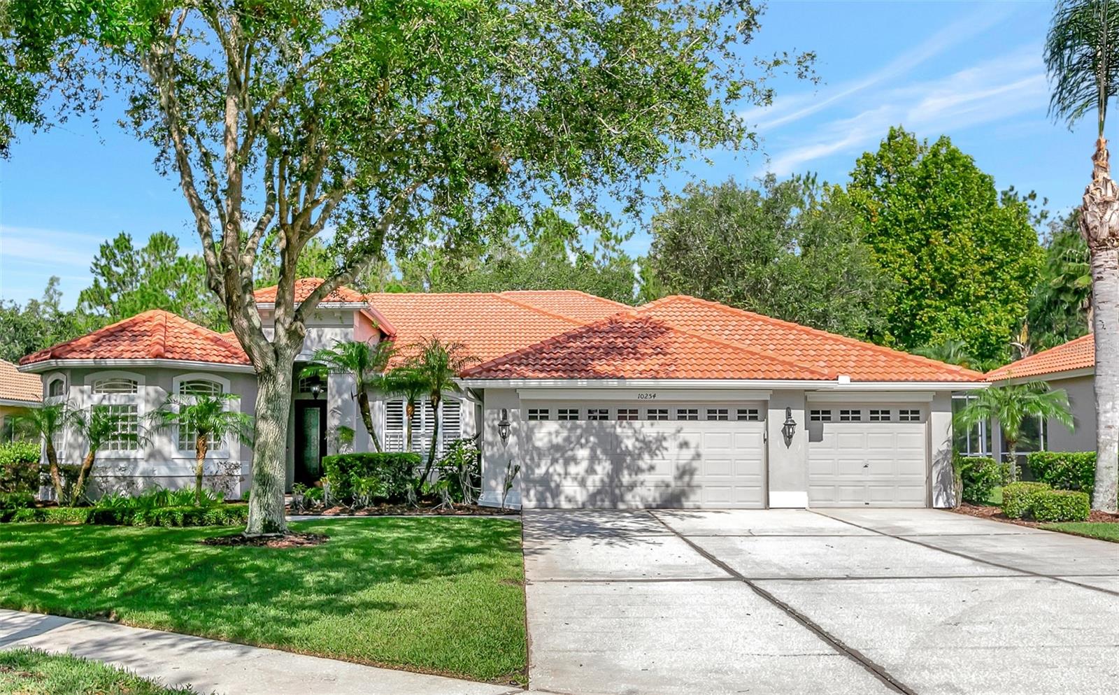 Under contract-accepting backup offers. Perfection! Experience sophistication and elegance in this 5 Bedroom + Bonus, 4 Bath, 3  Car Garage updated Executive Pool Home perfectly positioned on a private conservation lot in the double gated Estuary of Arbor Greene!   The open and bright floorplan welcomes you when you walk through distinctive double doors.  Dining Room and Living Room boast soaring ceilings, gleaming hardwood floors, plantation shutters, architectural columns, crown molding, 5 1/4 inch baseboards, soothing neutral paint, and upgraded light fixtures that sparkle like jewelry. This home has a dream kitchen with…stainless steel appliances including a gas range and wine refrigerator, upgraded winter white raised panel cabinetry with glass door inserts and crown molding, stone backsplash, distinctive granite counters, recessed lighting, and plenty of counter seating, along with a breakfast nook overlooking the pool and lush green conservation. Open floorplan kitchen adjoins the family room which is perfect for entertaining!   So much natural light throughout!  An attractive accent wall in the family room completes the attention to detail in the everyday living space.  Beautifully designed main floor Owners Suite features a distinctive accent wall with luxurious trimwork, sitting area, large walk-in closet and an ensuite bathroom which has his and hers vanities, a garden tub and an alluring spa-inspired redesigned shower! Main floor features 2 secondary bedrooms, guest bath, and pool bath.  Upstairs find two more bedrooms as well as a loft and bathroom!  Abundant space for family and guests!  Back downstairs, relax and unwind on your screened lanai around the sparkling pool, with expansive pavered deck area overlooking the private conservation. Arbor Greene is a premier manned gated  master planned community in the heart of New Tampa, and features a resort lifestyle with community pools, clubhouse, fitness center, tennis courts and so much more! Convenient to VA, Moffitt, AdventHealth, and BayCare Hospitals, USF, USAA, DTCC, vibrant shopping and restaurants, I-75 and all the amenities of the sought after New Tampa area!