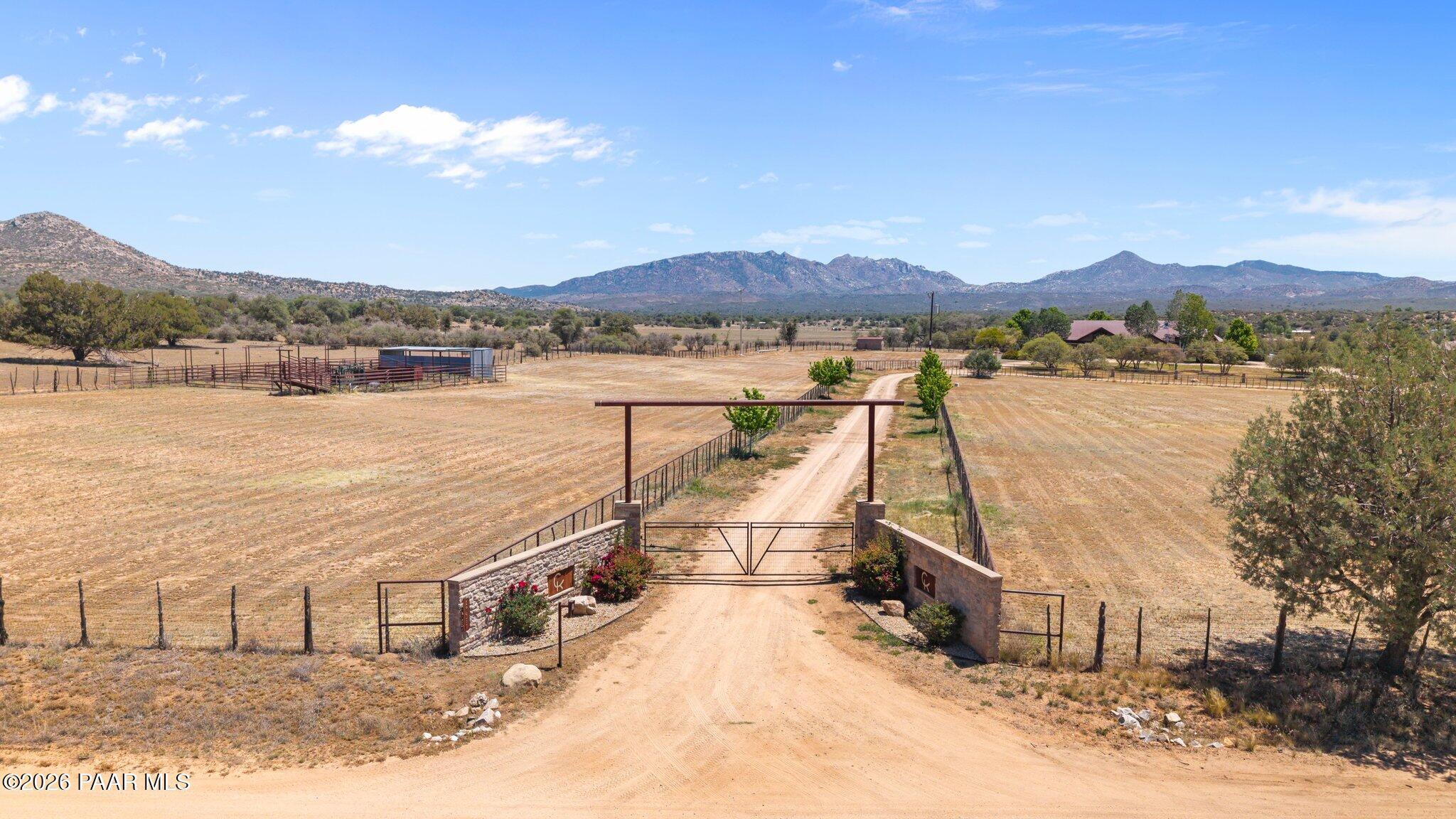 Welcome to a true legacy property in the heart of Skull Valley, Arizona spanning over (6) parcels on 50 acres, all being sold together as one complete equestrian and ranching estate. Anchored by a 5,337 sq. ft. primary residence with 3 bedrooms and 4 bathrooms, this offering is built for both refined living and serious working ranch functionality.  The main home overlooks a fully enclosed backyard with a sparkling pool, offering privacy and resort-style outdoor living. A spacious 3-bedroom, 2-bathroom guest house provides room for family or visitors, while a charming 2-bedroom, 1-bathroom cowboy bunk house adds versatility for ranch hands or additional guests.  Equestrian and hobbyist amenities abound: a 100' x 125' indoor riding arena and a 16-stall barn equipped with 2 hotwalkers make this a premier setup for training, boarding, or breeding. A massive 9,000 sq ft, 9-door workshop complete with heating and cooling, an office, and a bathroom offers exceptional space for equipment, projects, or business operations. The land itself is a standout: 35 flood-irrigated pastures of fescue and alfalfa sit atop a productive aquifer, supported by 3 high-producing wells. Energy independence is built in, with (3) 75-watt generators, (5) solar systems, and wind turbines powering the property. This is a rare opportunity to own a self-sufficient, income-ready ranch estate with room for family, livestock, and enterprise all in one unified offering.Rare 50 Acre Skull Valley Ranch, (6) Parcels, One Extraordinary Offering!  Additional Parcels Include:  300-20-009P, 300-20-009G, 300-20-009H, 300-20-007P, 300-20-009E, 300-20-007M