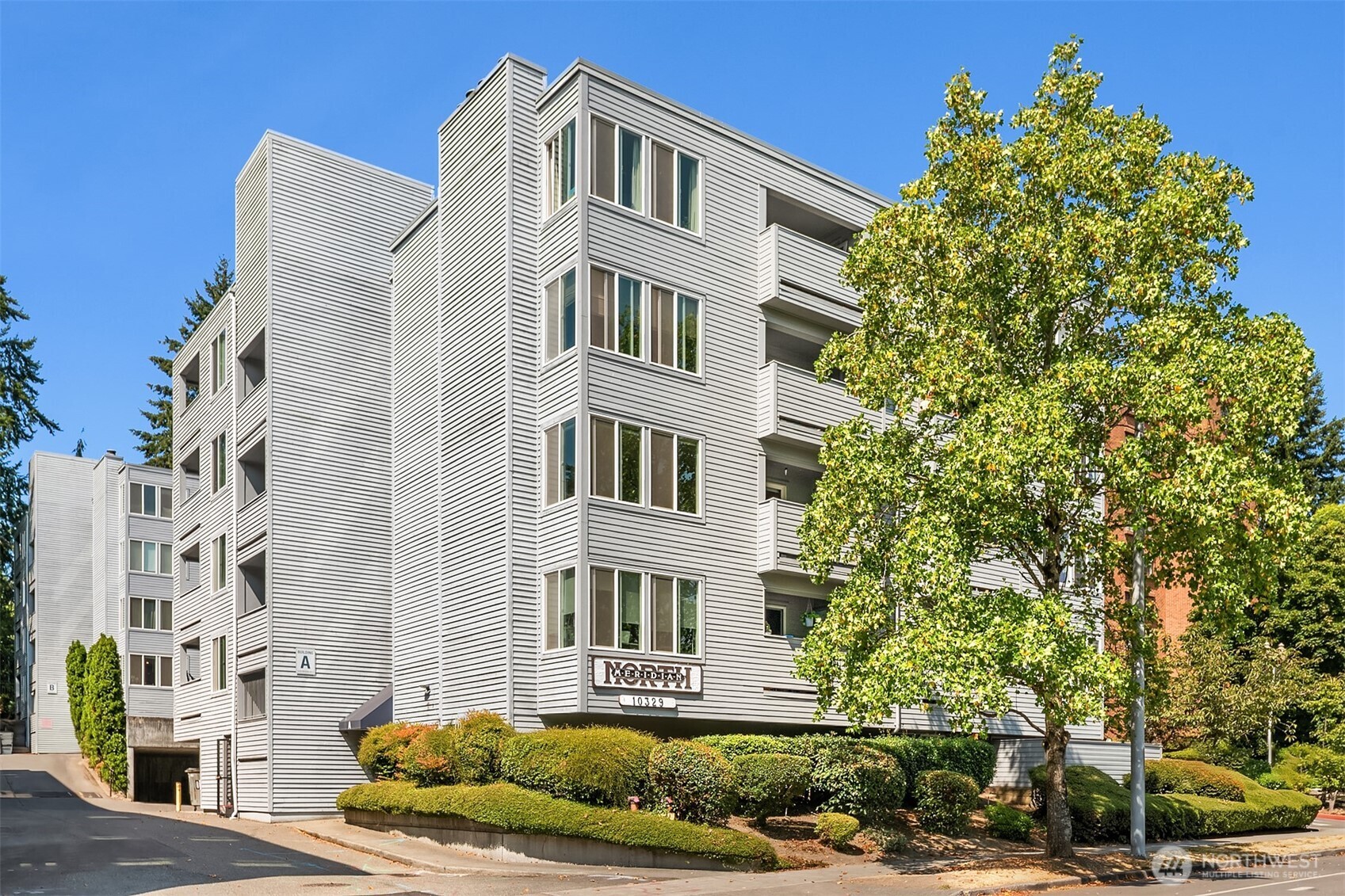 Bright and spacious 1-bedroom, 1-bath end-unit offering nearly 700 sq. ft. of comfortable living space. The inviting living room features a cozy wood-burning fireplace and opens to a private balcony, perfect for morning coffee or relaxing at the end of the day. The spacious bedroom also offers direct balcony access. Enjoy the convenience of in-unit laundry, two storage spaces, one in the building and one on the balcony, covered parking, and elevator access. Ideally located near North Seattle College, UW, Northgate Light Rail, UW Medicine, shopping, dining, and parks, with easy access to everything North Seattle has to offer. HOA dues include water, sewer, and garbage. With a well-managed building, no rental cap, and FHA approval, this condo offers a great combination of comfort, convenience, and flexibility.