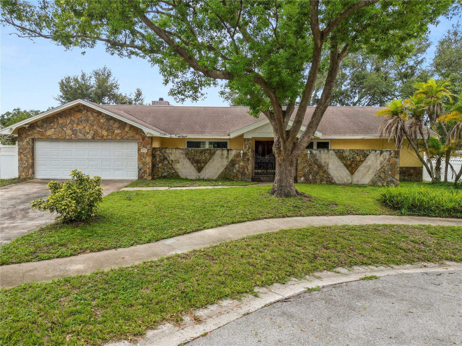 Opportunity awaits in Spanish Pines in Dunedin! Located on a quiet cul-de-sac just minutes from the Dunedin Causeway, Honeymoon Island, Gulf beaches, Pinellas Trail, shopping, dining and all that Dunedin has to offer, this spacious pool home combines an outstanding location with the size, lot and potential that are increasingly hard to find.Step inside and you'll discover a large, versatile floor plan with multiple living areas, generously sized bedrooms and plenty of room to spread out. A striking wood-burning stone fireplace adds warmth and character to the main living space, while the home's unique layout offers endless possibilities for updating and customization.Outside is where the Florida lifestyle really comes into play. The home features a screened outdoor living area, open private swimming pool and large privacy fenced backyard, providing plenty of space to entertain, relax or create the backyard retreat you've always wanted. The cul-de-sac location adds to the appeal, offering a more tucked-away residential setting while still being incredibly convenient to everything Dunedin is known for.Several important improvements have already been completed, including impact windows and sliding doors installed in 2018, a water heater replaced in 2018 and A/C from 2016.The home is ready for its next chapter and does need renovation and updating. For the buyer willing to put in the work, this is an opportunity to renovate to your own style while adding value to a substantial home in a highly desirable location.And here's another major advantage: enjoy being close to the water and beaches without the property being located in a designated flood zone requiring flood insurance. Whether you're an owner-occupant looking to create your dream Dunedin home, a renovator searching for your next project or an investor who recognizes the upside, 2010 Moss Court offers a compelling combination of location, square footage, pool, large yard, cul-de-sac setting and improvement potential.Bring your vision and unlock the possibilities of this spacious Dunedin pool home—just minutes from the causeway, beaches and Gulf Coast lifestyle!