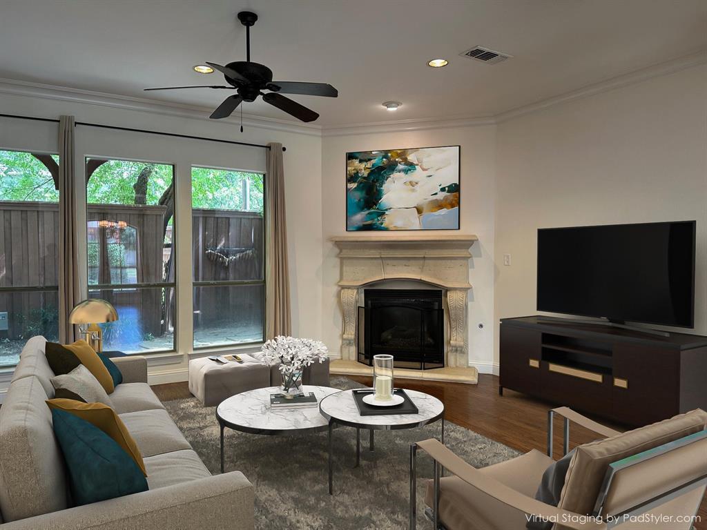 Living area with ornamental molding, recessed lighting, ceiling fan, wood finished floors, and a glass covered fireplace