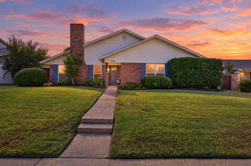 Thoughtful updates and inviting spaces make this one-story, 3-bedroom, 2-bath home in Plano’s 75093 ZIP code a standout! Hand-scraped hardwoods flow throughout the main living and dining areas, while the step-down living room features a striking stone fireplace with a stone hearth and mantel, as well as gas logs and a gas starter. The dining room offers decorator lighting plus room for a hutch. Just off the dining area, a versatile storage room adds built-in cabinetry, a two-tap keg cooler, space for a wine fridge and a backyard-facing pass-through window for easy entertaining. The beautifully updated kitchen boasts abundant cabinetry, expansive quartz countertops, stainless steel appliances, a five-burner gas stove and a portable butcher-block island. It opens to a comfortable den overlooking the backyard, creating a welcoming space to cook, gather and unwind. The spacious primary suite features an updated en-suite bath and generous walk-in closet. Both secondary bedrooms offer distinctive details, with white beadboard accenting one and board-and-batten detailing the other, complemented by decorator light fixtures and woven Roman shades. A separate utility room connects to the garage and provides hanging space for air-drying, built-in cabinets, open wall shelving and a freestanding shelf. Outdoor living shines beneath the large covered patio, complete with an oversized ceiling fan, recessed lighting, an electrical outlet and 2 swinging egg chairs. A 6-foot board-on-board cedar fence and brick planter box complete this inviting backyard retreat. Conveniently located just minutes from shopping, restaurants and George Bush Highway, this home puts everyday essentials and dining favorites within easy reach! From relaxed mornings in the den to evenings spent unwinding on the covered patio, this home offers inviting spaces to enjoy every day. Warm finishes, charming accents and thoughtful updates create a welcoming setting for quiet moments and memorable gatherings.