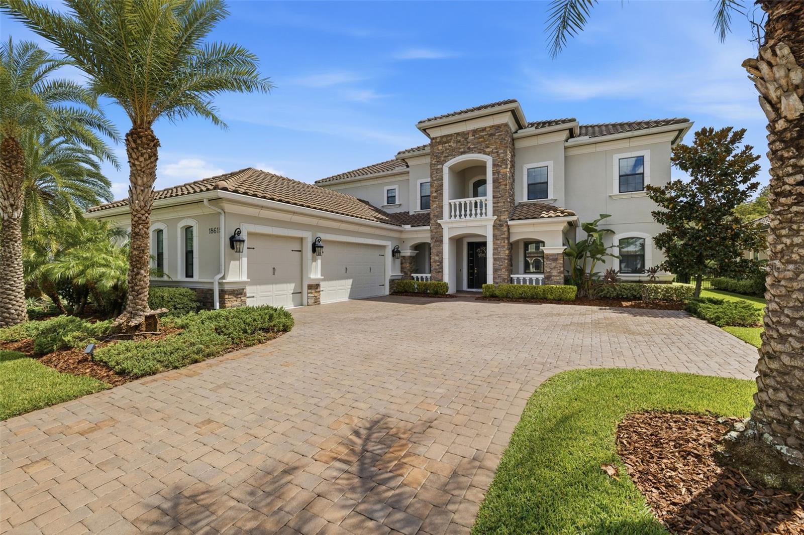 Distinguished Estate set within the prestigious gated community of Cheval in Lutz, this exceptional residence offers the quiet luxury of a golf-and-country-club lifestyle. Known for its winding championship golf course, lush cypress conservation areas, and 24-hour manned security,Cheval offers a priceless blend of resort-like amenities, privacy, and beautiful Floridian landscapes. Built in 2020 and encompassing an impressive 5,224 SF, this two-story estate boasts seven beds, office, media room, six baths, 3-car garage, and pool, on a gorgeous 0.28-acre lot, with stunning water and conservation views. From the moment of arrival, the home's scale and architectural presence will enchant your guests. The paved driveway, stone-accented façade, and tile roof create an elegant welcome atmosphere. Wood ceramic tile flooring extends throughout the principal living spaces, a sophisticated foundation for the home's first floor. And wall to wall upgraded carpet upstairs adds coziness to the environment.A flexible study, office, or playroom is positioned near the entrance, while the formal dining room provides an elegant setting for entertaining. Here, as throughout the home's main social areas you will find coffered ceilings, crown molding, wainscoting, and custom millwork. The gourmet kitchen is designed with both culinary performance and everyday living in mind, featuring white cabinetry, stainless steel appliances, island, gas cooking, double ovens, a pot filler, exhaust vent and a walk-in pantry, with a custom breakfast nook. The breakfast and eating area have been thoughtfully transformed with custom wood cabinetry, built-in bench seating, integrated storage drawers, and a decorative accent wall treatment. The home opens through triple sliding glass doors to an outdoor retreat centered around the large pool and expansive seating area. This setting enjoys tranquil wildlife, conservation and pond backdrops.An outdoor kitchen features a substantial 28-inch cooking-surface barbecue/grill—for leisurely dinners, weekend gatherings, and entertaining throughout Florida's long outdoor season. The primary suite wing is a peaceful retreat, offering wooded and nature views. Barn doors leading to the spa-inspired master bath featuring his/her vanities, an expansive built-in walk-in closet, soaking tub, and a separate walk-in shower. A first-floor en-suite guest bedroom offers exceptional privacy for guests or multigenerational living.A full bathroom with pool access adds another layer of convenience when entertaining outdoors. Upstairs, well-appointed bedrooms and flexible spaces with generous storage. Substantial Bonus Room for leisure, a Media Room offers an immersive theater/entertainment space, with an upgraded audio system with Dolby Atmos and subwoofer. A flexible gym/workout and office/workspace bedrooms. A Jack-and-Jill bath serves the rooms currently configured for these purposes. Thoughtful improvements throughout: A whole-house Generac generator (including the pool pump). Hurricane impact-resistant windows throughout. Water softener and carbon filtration, complemented by an under-counter reverse-osmosis purification system. The HVAC systems benefit from enhanced air filtration incorporating UV-light treatment and carbon filtration.Ecobee smart thermostats and controls have also replaced the original builder-grade controls. Security system incorporating motion detectors and security cameras covering the common areas, including the front entrance.