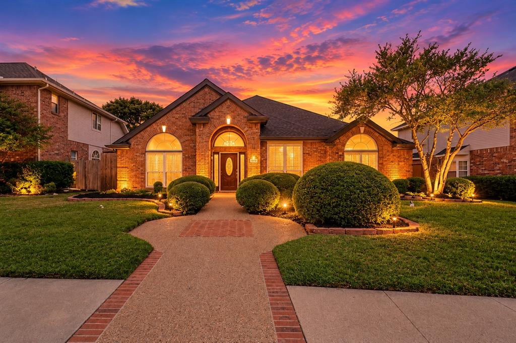 Timeless architectural charm meets effortless modern living, nestled in an established neighborhood in the heart of Plano! From its beautiful brick façade and distinctive arched windows to its light-filled interiors and meticulous attention to detail, this captivating single-story residence offers unique character, comfort, and sophistication. Step inside to discover soaring vaulted ceilings, graceful archways, elegant columns, and expansive living spaces accented by plantation shutters and abundant natural light. Designed for both entertaining and everyday living, the thoughtfully connected living and dining areas offer versatility and an inviting sense of openness. The spacious family room features a cozy fireplace, custom built-ins, and picturesque views of the private backyard, creating the perfect setting to gather and unwind. At the heart of the home, the generously appointed kitchen offers spacious countertops, stainless-steel appliances, a center island with an electric cooktop, abundant cabinetry, and a convenient breakfast area, all beautifully framed by a wall of windows. The primary suite provides a peaceful retreat, complemented by a spacious en suite bathroom featuring dual vanities, a soaking tub, and a separate walk-in shower. Three additional bedrooms offer flexibility for guests, a home office, or personalized living spaces. Outdoors, a private, tree-shaded backyard with an open patio creates an inviting escape for morning coffee, weekend gatherings, or quiet evenings beneath mature trees. Ideally positioned in the highly regarded Plano ISD, with NO HOA, you'll enjoy the freedom and exceptional access to corporate headquarters, luxury shopping, fine dining, elite entertainment, everyday essentials, and major thoroughfares—an outstanding opportunity to own a piece of paradise in one of Plano's most convenient settings. Take advantage before it's gone and schedule your private showing today!