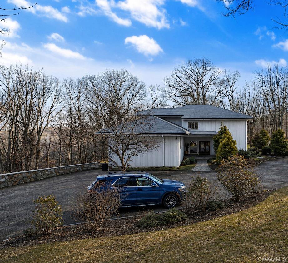 This magnificent residence embodies quintessential Bedford living, gracefully set on a quiet, picturesque cul-de-sac. Ideally located just minutes from Bedford Village and Pound Ridge, the home offers effortless access to the Mianus River Gorge and miles of pristine scenic hiking trails.A gracious entrance foyer introduces the main level, where a dramatic living room showcases soaring ceilings, an open-concept design, and walls of windows framing tranquil woodland views. A stunning stone fireplace serves as a focal point, creating an atmosphere that is both refined and inviting. The impeccably designed chef’s kitchen features custom cabinetry, premium stainless-steel appliances, and seamless flow into the formal dining room—perfect for elegant gatherings. A sun-drenched breakfast nook provides an intimate setting for morning coffee. Rich wood floors extend throughout the home, enhancing its timeless sophistication.Thoughtfully designed for both elevated entertaining and comfortable everyday living, the home offers exceptional flow and flexibility. A few steps up, three generously proportioned bedrooms are complemented by a newly renovated full bath.The upper level reveals an expansive, light-filled loft overlooking the living room, complete with a fireplace and ideal as a refined lounge or library. This level leads to the serene primary suite, featuring a spacious walk-in closet and a beautifully appointed spa-like bath with a soaking tub. An additional large room off the loft offers endless possibilities as a private office, guest suite, or creative retreat.The lower level offers a private rear entrance with direct access to both the main living area and the basement. This level includes a dedicated laundry area with a new washer and dryer. A stylishly updated powder room adds convenience, while the newly renovated basement features new windows, refined flooring, a versatile bonus room, and an updated full bath.Completing this exceptional property is a spacious two-car garage, offering both functionality and convenience.A true MUST See!