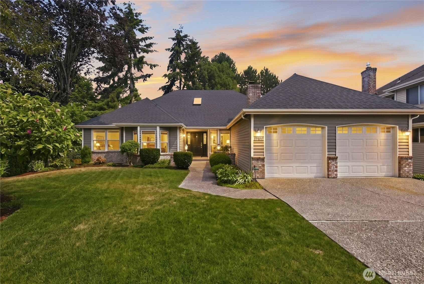 Luxury, space, and versatility come together in this beautifully updated Bellevue rambler, tucked into a quiet cul-de-sac just minutes from Microsoft, Idylwood Park, and Marymoor Park. Built by Burnstead, the main level combines easy rambler living with the space and refinement of a luxury home, featuring hardwood floors, vaulted ceilings, skylights, and oversized windows filling the home with natural light. The spacious kitchen includes island seating and a bright breakfast nook, flowing effortlessly into the family room and dining area. The impressive main-floor primary suite offers high ceilings, two large walk-in closets, and a remodeled five-piece bath, while two additional bedrooms and an updated full bath complete the level.    The daylight lower level feels like an entirely separate second home, with soaring ceilings, exposed beams, abundant windows, and exceptional natural light. This expansive space includes a generous second primary suite, large bonus room, kitchenette, multiple office or flex spaces, a spa-like double shower, and an incredible cedar sauna. A private exterior entrance leads directly to the covered patio and fully fenced backyard surrounded by mature landscaping.    Additional highlights include laundry on both levels, two fireplaces, air conditioning, a 2021 composite roof, and a finished two-car garage. Ideally located with convenient access to Downtown Bellevue, Redmond, Highway 520, parks, trails, and the Bellevue School District. Pre-inspected!