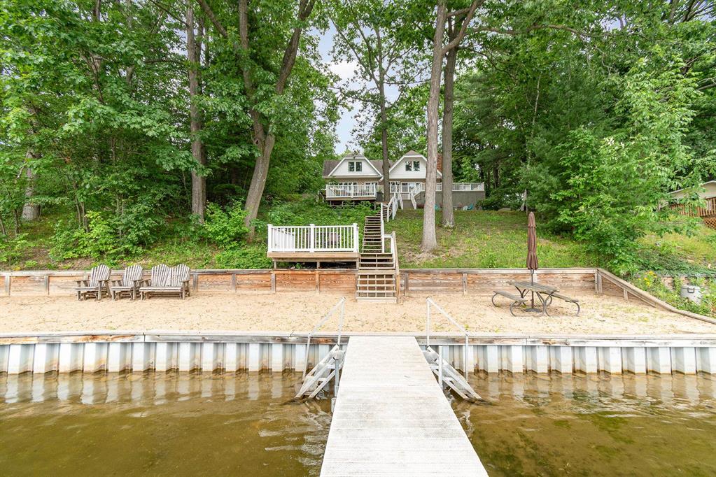 Motivated Seller bring all offers! Welcome to this stunning lakeside retreat at 7670 Five Lakes Dr, Farwell, MI! Nestled on over an acre of picturesque waterfront land, this enchanting 4-bedroom, home offers lakefront living with over 105 feet of water frontage and mesmerizing lake views. Step inside to be greeted by a spacious, sunlit kitchen adorned with rich, dark wood cabinetry, sleek stainless-steel appliances (chefs stove), and a stylish countertop island. A cozy family room with wood-burning fireplace. The huge living room, featuring a warm fireplace (gas), provides a perfect place for relaxation and enjoyment with the extended family. The inviting multi-level deck, seamlessly accessible from the living areas, provides an idyllic space for outdoor entertaining with serene lake views as your backdrop. Imagine evenings by the outdoor fire pit, with lush green trees all around. Additional features of this impressive property include a 24 kw Generac generator (2022), two new furnaces (2024), two new central air units (2024), roof (2018), and a newer water treatment system. A relaxing spa adds a touch of luxury to this already impressive home. Two wooded lots across the street offer opportunities for additional building. Surrounded by beauty and designed for comfort, this captivating lakeside home is one of the largest on Five Lakes which is an all sports lake. Experience the perfect blend of nature and modern living at this charming Lakehouse. This home is ADA accessible with Chair lifts (negotiable) and grab bars. Home is sold mostly furnished. Pontoon boat and 70hp motor included. Dont miss your chance to call this tranquil retreat your own.