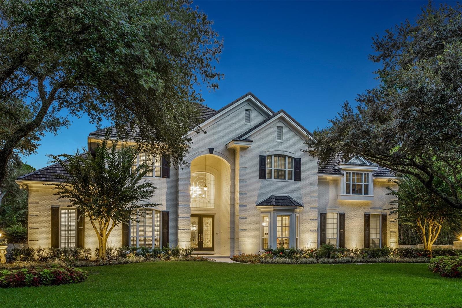 Sometimes the perfect home finds you twice—this one is now available for the next lucky owner. Purchased earlier this year, the sellers are only parting with it because they unexpectedly found their forever dream home. Their change of plans is your opportunity to own one of the finest estates in The Reserve at Tampa Palms, an exclusive gated community with 24-hour security.

This 6,590 SF estate sits on nearly half an acre with no front or rear neighbors, offering unmatched privacy and tranquil surroundings. The screened pool and spa overlook a peaceful pond and lush conservation area, creating a stunning backdrop where you can relax in complete privacy and enjoy nature every day. The home inspected exceptionally when purchased just months ago and remains in pristine, move-in-ready condition. A full inspection report can be shared with serious buyers to confirm how clean and well-maintained this property truly is.

The grand double-door entry opens to soaring 30-foot ceilings, a dazzling chandelier, and sleek 31” x 31” marble floors. A 350-bottle climate-controlled wine wall—both functional and a statement piece—divides the formal living and dining rooms. Expansive glass doors and an arched transom window flood the living room with natural light and frame sweeping views of the pool, spa, pond, and conservation beyond.

The chef’s kitchen is equipped with a Viking 8-burner gas range with double ovens, Sub-Zero refrigerator, Miele steamer, dual LG dishwashers, Viking chill drawers, and a farmhouse sink, all centered around a massive 9’ x 10’ granite island.

The downstairs primary suite offers a sitting area, gas fireplace, dual walk-in closets, and spa-like bath with jetted tub and walk-in shower. A private study with custom built-ins sits nearby. Upstairs are four additional bedrooms (three ensuite) and a media/game room.

Recent updates include:
 • Tile roof (2019)
 • 3.5 newer AC units (all within 5 years)
 • 3 hot water heaters (2020)
 • Whole-home water filtration (2021)
 • Sonos sound system

The Reserve at Tampa Palms provides access to Compton Park’s exclusive amenities—Junior-Olympic pool, tennis & pickleball courts, playgrounds, and scenic walking trails—all within minutes of top-rated schools, shopping, hospitals, and Tampa Palms Golf & Country Club.

Rarely does a home of this caliber, in this condition, return to the market. Pre-inspected, impeccably maintained, and offering one of the most peaceful backyard settings in Tampa—don’t miss it.