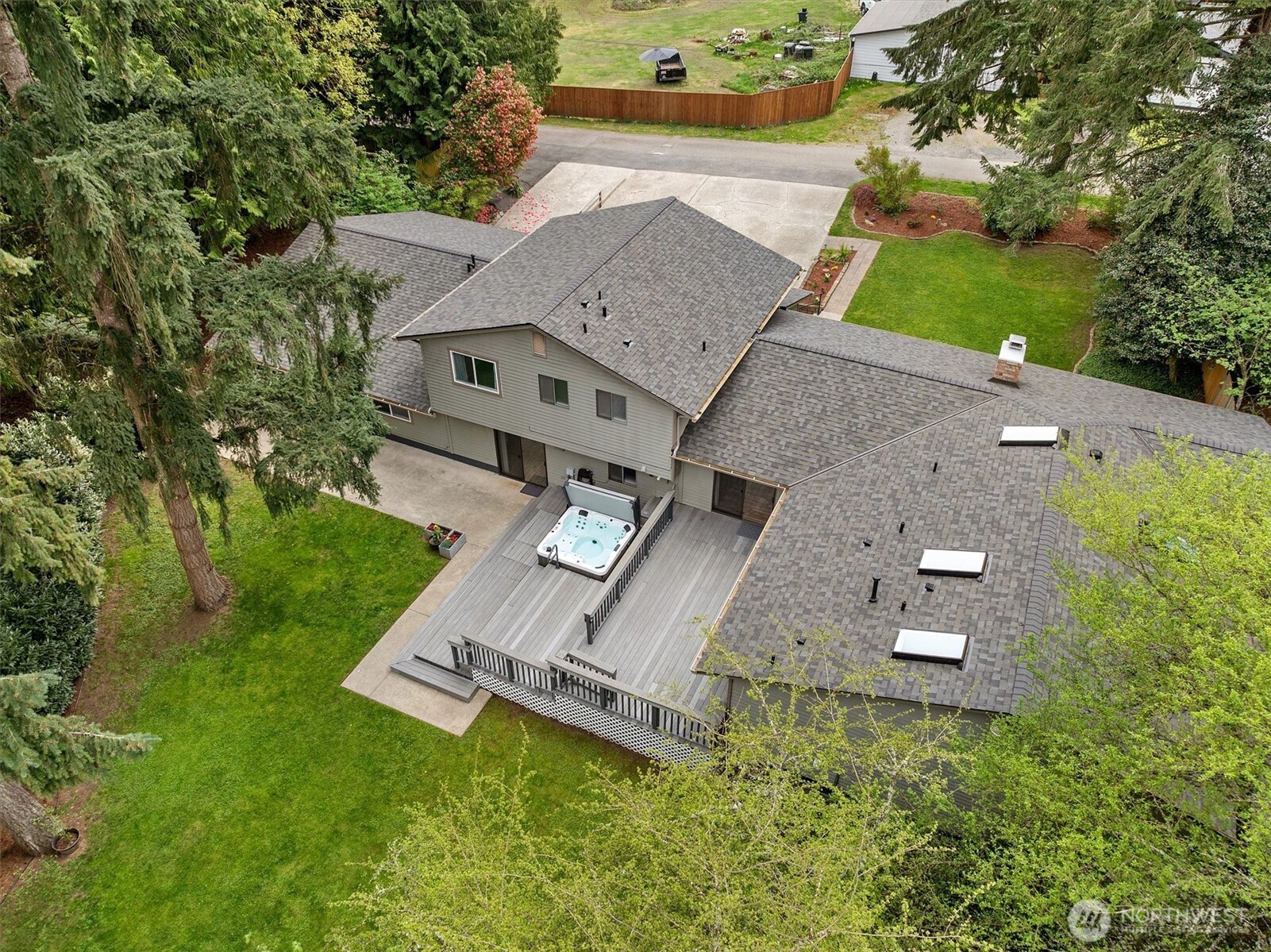 PRICE IMPROVEMENT! Set on a beautifully expansive acre in a quiet neighborhood, this exceptional property offers a rare blend of space, flexibility, & lifestyle-ideal for multi-generational living. The main residence spans 3,370 sq ft & features multiple bedrooms, including a main floor primary suite with a beautifully remodeled bath with heated floors, plus new carpet throughout the main living areas. Generous living spaces extend across multiple levels, including a lower level with rec room, theater room, & additional room. A standout feature is the attached "no stairs" 1,300 sq ft ADU-like living space w/garage access, offering incredible versatility with its own living room, updated 3/4 bath, tankless water heater, separate laundry, & stylish full kitchen/dining area, plus two additional rooms—perfect for extended living, guests, or creative use. Step outside to a tiered composite Trex deck with hot tub, overlooking a fully fenced yard framed by mature laurel hedging, with additional open space beyond. A 24x35 covered RV/toy storage structure, 2 storage sheds, 11 off-street parking spaces, & a 9’ garage bay provide exceptional utility. Located within the highly desirable Issaquah School District & just a 6-minute drive to K-12 schools, this property is also minutes to shopping, I-90, & I-405 for easy commuting. Additional highlights include a new 50-year roof, 600-amp electrical service, & no HOA. A truly rare opportunity offering space, function, & flexibility.
