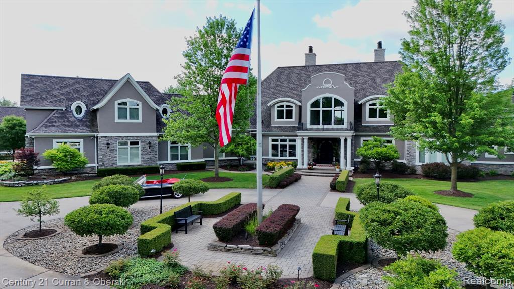 Introducing a truly one-of-a-kind gated estate in South Lyon, crafted by renowned builder Patrick Widing Custom Homes, a car collector’s dream and an entertainer’s paradise. This meticulously designed Country French Colonial spans 8.95 acres and over 15 million dollars has been invested into creating this world class property. Boasting over 9,800 sq ft above grade (plus a 5,324 sq ft of finished lower level), the home includes a private guest house, 6 bedrooms, 7 full and 1 half baths, and top-tier luxury finishes throughout. The first-floor primary suite features a fireplace, hardwood floors, marble spa bath with heated floors, and quartz countertops. The estate is ideal for automotive enthusiasts with multiple structures housing over 30 cars—each a mechanic's dream garage. Outdoor highlights include a new $700K resort-style pool and pool house, a 4-hole par-3 golf course, and professionally landscaped grounds offering unparalleled privacy and serenity. Inside, you'll find an exquisite study with judges paneling, multiple limestone fireplaces, a phenomenal gourmet kitchen, a sunroom, and a family room designed for relaxation and entertaining. The lower level features a full kitchen, bar with custom millwork, home theater, temperature-controlled wine cellar, and elevator access. Over $250K in custom lighting and Control4 smart home automation elevate this estate to a new level of luxury. Every inch is well-appointed with detailed woodwork, soaring ceilings, and panoramic views.
This is more than a home—it's a private resort estate unlike anything else on the market.