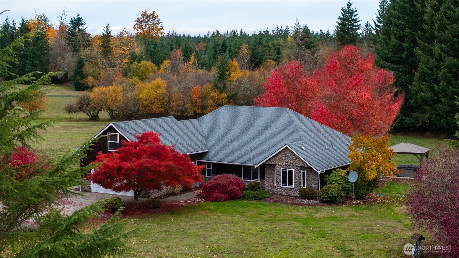 Gorgeous 3200+ sq. ft. single story 3 bed/3 bath home sits at the end of a private road. 5 flat acres with 1.5 ac. of timber, a 36 x 48 shop, green house, chicken coup & garden. Exterior recently painted & stained. Stunning rock work throughout the interior & exterior.  Large living room w/gas fireplace, vaulted ceilings, double French doors opening to a large patio, wildlife & a covered hot tub. Kitchen has tile counters & floors, lg. pantry, stainless appliances & plenty of space to work.  Second living room area opens up to a dining room giving plenty of room to entertain. Large primary bedroom w/walk in closet, 5 piece bath, sitting area & a door to that beautiful patio. Room above garage would make a great game room, gym or office.
