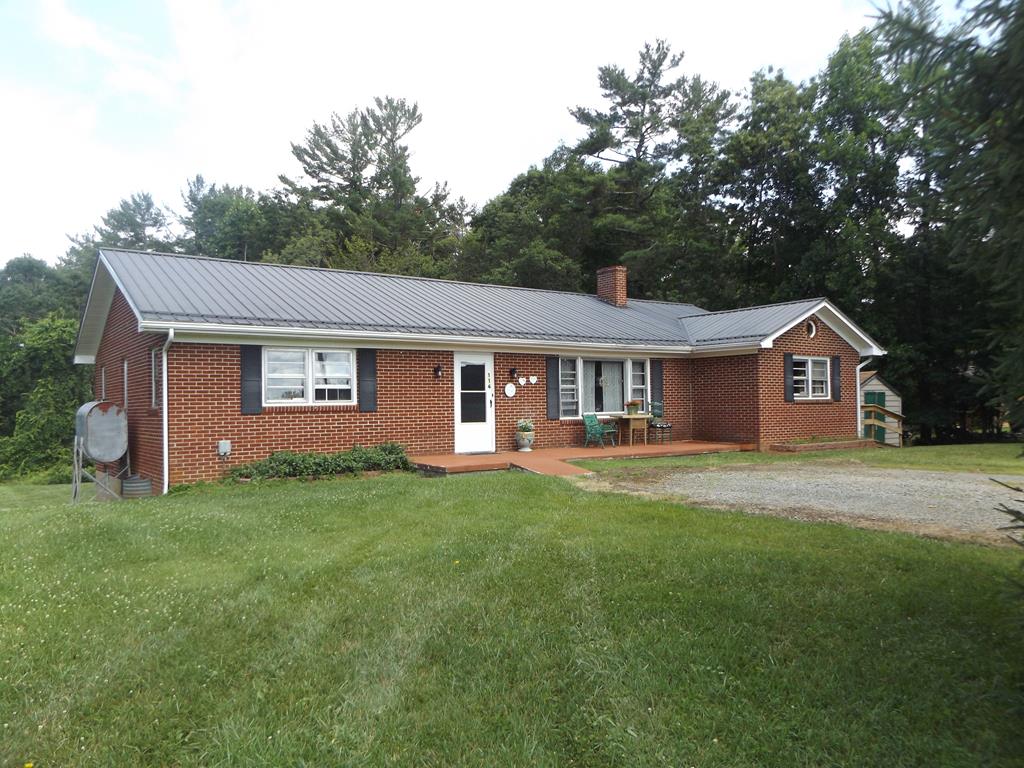 3 bedroom brick ranch home with metal roof, full basement, metal roof sitting on 3.957 +/- acres! Home features main level living with large living room with wood burning fireplace, large kitchen with all major appliances, formal dining room, large master bedroom, full bathroom 2 nice sized guest bedrooms and laundry/mud room! Other features include full walkout basement with half bathroom, workshop area, side deck, front porch, metal roof and the list goes on! Don't miss out on this nice home in a country setting sitting on 3.957 +/- acres in a convenient location just minutes to Galax and surrounding areas!