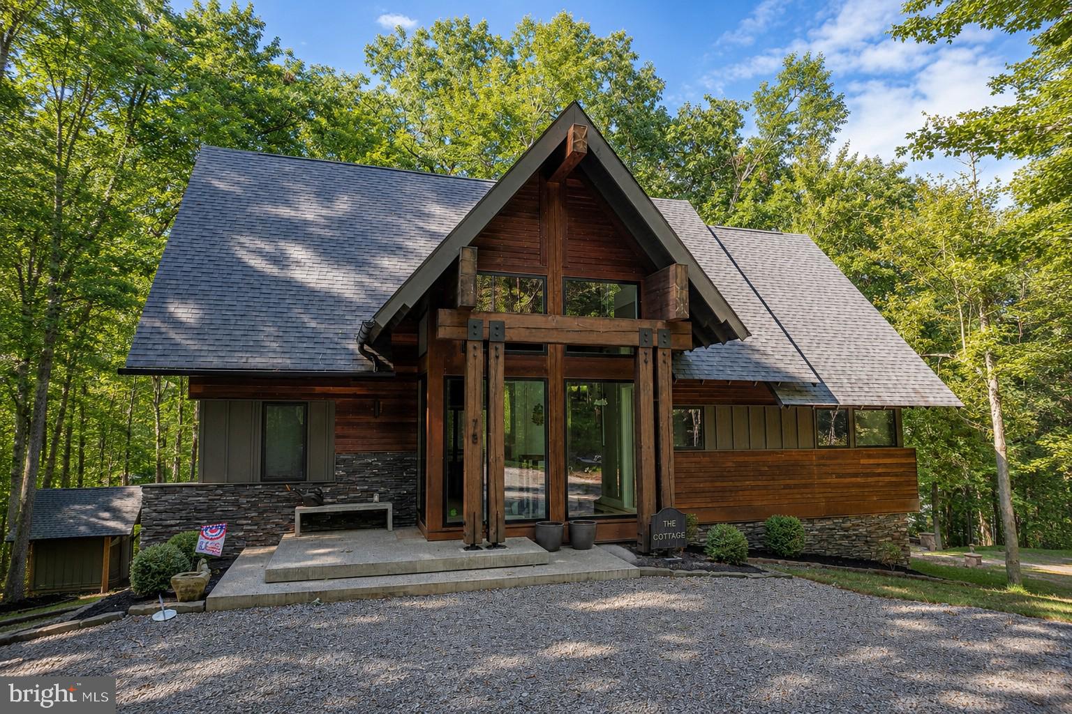 Experience the very best of Deep Creek Lake living in this exceptional 3-bedroom, 3.5-bath luxury lakefront residence in the prestigious Thousand Acres community. Thoughtfully designed with sophisticated finishes and an effortless connection to the outdoors, this extraordinary home offers the perfect blend of refined elegance and relaxed lakeside living.The main level welcomes you with an impressive open-concept living space highlighted by an expansive accordion glass wall that seamlessly opens to the deck, creating an exceptional indoor-outdoor entertaining experience. The designer kitchen is equally impressive, featuring a stunning waterfall-edge island, premium stainless-steel appliances, and high-end finishes throughout. A screened outdoor dining area provides the perfect setting for enjoying meals and long summer evenings overlooking the lake.The main-level primary suite offers a private retreat with a beautifully appointed, spa-inspired bathroom designed for ultimate relaxation. Additional bedrooms and living spaces provide exceptional accommodations for family and guests, all finished with the quality and attention to detail expected in a true luxury property.Outside, 117 feet of prime Deep Creek Lake frontage creates an unparalleled waterfront setting, complete with a Type-A dock offering outstanding access to the water. Whether you're boating, swimming, entertaining, or simply taking in the changing seasons, this is lakefront living at its finest.Adding to the appeal is the highly desirable Thousand Acres community, home to one of Maryland's premier semi-private golf courses. From exceptional architecture and elevated finishes to breathtaking lakefront living and world-class recreation just outside your door, this remarkable property represents a rare opportunity to own a truly special Deep Creek Lake retreat.