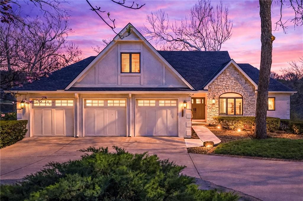 Expansive lake views. Move-in ready. An unimaginable lifestyle. 8111 NW Hillside Drive is the waterfront home you've been waiting for. This extensively renovated 1.5-story lakefront home offers 4 bedrooms, 4.1 bathrooms, and a 3-car garage, thoughtfully designed to capture sweeping views of Weatherby Lake.The open-concept main level features a spacious great room, dining area, breakfast area, and beautifully updated kitchen, all oriented toward the water to maximize the east-facing views. The main-level primary suite provides a peaceful retreat with a spacious bathroom and separate his-and-hers closets. Upstairs, a private secondary suite with an adjacent den or office offers an ideal space for guests, work-from-home flexibility, or multigenerational living. A separate flex room on the second level adds additional versatility for a playroom, lounge, or creative space.The walkout lower level is built for entertaining and extended stays, featuring two bedrooms, two full bathrooms, a large family room, a wet bar with second stove and refrigerator, and a dedicated workshop.Outdoors, the home offers multiple lake-facing living spaces, including a large deck off the main level, a patio below, and a beautiful paver patio near the shoreline, perfect for gathering with friends, enjoying quiet evenings, or taking in the peaceful lake setting. Two private docks provide direct access to boating, swimming, fishing, sailing, and paddle-boarding right from your backyard.Located in the vibrant Weatherby Lake community, residents enjoy full lake amenities, city parks, tennis and pickle-ball courts, trails, active community and civic groups, and year-round events—all just minutes from modern conveniences, Parkville, downtown Kansas City, Johnson County, and KCI Airport.Homes of this quality on Weatherby Lake rarely come available. Renovated, waterfront, and ready to enjoy, this is lake living at its very best.