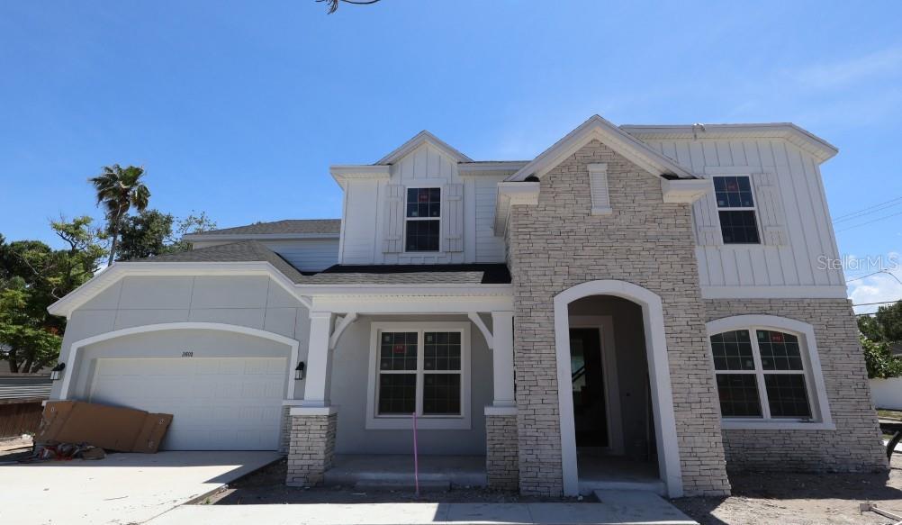 Under Construction. This may be one of the most impressive layouts and designs David Weekley Homes has ever built in South Tampa—an absolute showstopper. Located in the center of South Tampa with many other newly built homes.From the moment you arrive, the home commands attention with its grand presence on the homesite. Layered architectural details and rich exterior textures create striking curb appeal. Oversized garage, enough space for 3 cars or 2 plus plenty of storage space!Entering from the garage, you’re welcomed by a thoughtfully designed full-size mudroom featuring a backpack rack, storage bench, and dedicated countertop—perfect for family organization or a convenient charging station. From the front, you are greeted by the inviting front porch.  Once inside, a private home office sits on one side and a first-floor guest suite on the other—why choose when you can have both?The heart of the home is the expansive great room, anchored by a sophisticated kitchen designed to impress. Cabinets extend to the ceiling, complemented by a chevron-patterned polished backsplash, quartz countertops, and beautiful RevWood flooring. The kitchen also includes a built-in trash and recycling center, pots-and-pans drawer beneath the cooktop, and soft-close doors and drawers throughout.Just beyond, the covered lanai sets the stage for seamless indoor-outdoor living. Prepped for a future outdoor kitchen and television, the space overlooks a stunning swimming pool, sun shelf, pool bath, and fully fenced backyard—perfect for entertaining or relaxing year-round.Upstairs, architectural square spindles guide you to a spacious bonus room, ideal for movie nights or game days. Three secondary bedrooms are located on one side of the home, including one en-suite, while the primary bedroom is privately situated on the opposite wing—so expansive it feels like its own retreat. A private foyer/sitting area with a beverage refrigerator and countertop welcomes you into the space, which is filled with natural light and generous proportions.The owner’s bathroom is a true spa experience, featuring a dual-zone shower with a ceiling-mounted rain showerhead, built-in niche, freestanding soaking tub, and dual vanities with ample storage. The oversized walk-in closet—larger than some secondary bedrooms—offers customizable his-and-her spaces and includes a discreet door leading directly to the laundry room for ultimate convenience. The laundry room is equipped with a folding counter and soaking sink.Additional highlights include 8-foot solid-core doors, impact-resistant windows, full irrigation system, gutters, epoxy garage floor, and no carpet throughout. The home also comes with a comprehensive warranty: one year on workmanship and materials, two years on major mechanical systems including plumbing, electrical, and HVAC, and a ten-year structural warranty.This home truly has it all, and we can’t wait to share it with you.