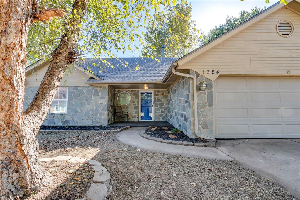 Classic Edmond living with a neighborhood park for only $126 a square foot! This 4 bedroom, 3 bathroom house sits tucked onto a quiet block of the Twin Oaks neighborhood with mature trees, well-traveled sidewalks, and all of the conveniences of the city a half a mile away. Situated just North of Edmond Rd and just West of Western Avenue, it's the ideal blend of city and rural.

Large flower beds abut the beautiful Pennsylvania blue flagstone, and welcome you into an oversized living room with high ceilings and lots of warm library panel woodwork. The stone carries into the house with a big cozy fireplace and hearth, perfect for making memories and taking selfies. Tile floors, granite countertops, and stainless steel appliances round out the highlights of the common areas. Oh and don't miss the storybook window bench in the dining room complete with massive drawers for storage.

Down the hall, you'll find a huge primary bedroom with abundant closet space and an updated primary en suite. The oversized vanity cabinet with twin sinks is a dream come true. Tech fans may notice presence of Philips Wiz lighting above the sinks, which allows you to customize your light color and connect to wifi or bluetooth and even has voice activation capabilities. The whole house is fitted with Wiz lights. Back in the hall, a beautifully remodeled bathroom separates one room from another large bedroom featuring a custom paint job and large closet.

Upstairs has two large bedrooms which could also function as offices or playrooms etc. Storage abounds in the third bathroom which sits atop the stairs and features a nice double vanity and a cozy blue shower. But, back down the extra-wide stairs, through the back door, is where perhaps the most exciting feature lies. A massive stone patio with a big chunky Cedar and Pine gabled roof cover. It's got room for a patio set and ping pong table and fire pit with room to spare. Note the shade from the big healthy Sycamore tree