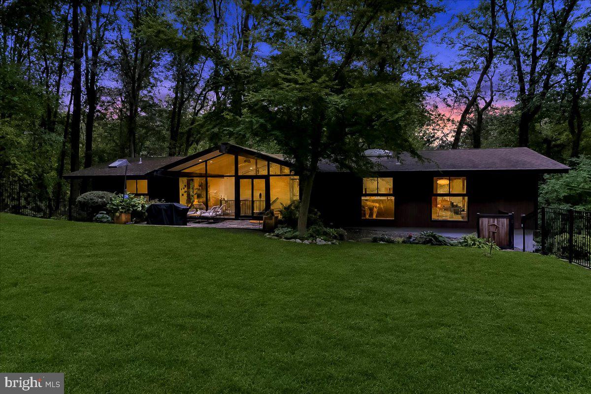 Step back in time to 1966.  Think Mad Men! This nearly 3,000 Sq Ft Robert McElroy designed home has only had 3 owners who have preserved this wonderful example of mid-century modern architecture.  It blends seemlessly with nature on a 1.8 acre wooded hillside. Conveniently located in Tredyffrin Easttown School District.  Some of the classic architectural details that fit the mid-century modern aesthetic are the floor to ceiling gable glass walls, A vaulted Living Room with exposed beams, an open floor plan connecting living and dining spaces, and a deck spanning the rear of the home has new wire railings and fresh stain.  Every room opens to the woods bringing the outdoors in.  The Great Room (Living Room)  has an iconic Freestanding Malm style, wood burning fireplace. All renovations have been done preserving the clean modern lines that McElroy intended. Original hardwoods refinished on the main level.  Original walnut kitchen cabinets have been restored and are soft closing, Beautiful neutral quartz worktops.  Deep stainless sink and stainless appliances.  Walk-in Pantry with Sage Green Contemporary cabinets, Coffee Bar, and 2nd full sized Stainless Refrigerator.  Closets done by California Closets to help you stay organized .  Lower level has Maple hardwoods.  New Carrier HVAC system.  New Epoxied Laundry Room and oversized 2 car garage.  The garage has a built in PRX Performance Gym that folds into the wall  to make room for cars when not in use.  The front yard has been fenced and gated for pets and children.  From the highest point on the property you can see Valley Forge Park.  There is a beautiful garden with Pennsylvania native plants right outside the fence.  The current owners have carefully maintained the peacefull vibe of the property by adding various garden/ patio/deck seating areas and additional landscaping while maintaining the architechtural integrity both inside and out.  Custom Shed to store your gardening suppies and outdoor furniture.  The children have built a charming tepee from twigs in the yard. Area deer use it during rainstorms and to bed down at night. The floorplan offers flexability and rooms can be changed to fit your specific needs. If you have been dreaming of an adult Tree House with all the modern comforts we have come to expect, look no further.  Pugh Rd has become a bit of a concentration of significant Modern Architecture.  In addtion to this home, two other nearby homes include works by other notable modern architects associaled with the 'Philadelphia School", which is a globally influential mid-century architectural and urban planning movement centered around The University of Pennsylvania (Stuart Weitzman School of Design)  For example 560 Pugh Road was designed by Kjell Ingebrigsten.   356 Pugh Road is another well known McElroy house  So, if you are ready for a new adventure, stop by my open houses this weekend on Saturday and Sunday from 1-3PM on both days.