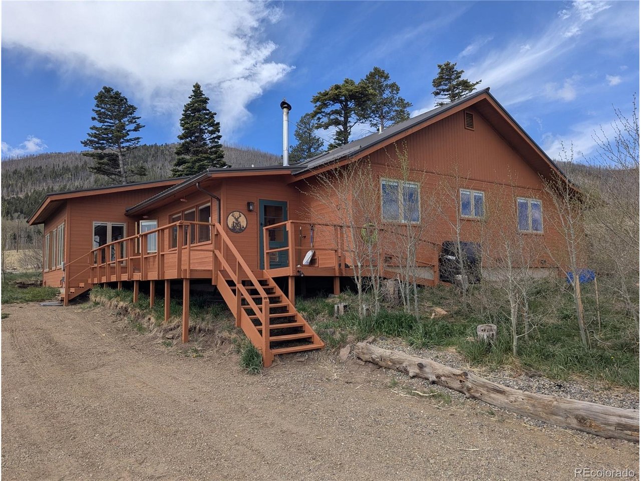 One-level living, and move-in ready! Enjoy the views from every direction of wildflower-filled meadows, deer and elk, and near and distant mountains.  The home comes with 2 adjoining parcels for nearly 5-acres and a brand new septic tank! Large enclosed porch/mud room provides space to take off your boots and stock plenty of firewood for the new wood-burning stove. The porch leads to a sunroom with ample windows for you to gaze at the stars without ever getting out of the indoor hot tub! The home features an open concept floor plan with symmetry in the 4 bedrooms with 2 baths between, or, a couple of options for offices spaces. The chef's kitchen features matching stainless-steel appliances, a large island, and an enormous pantry/laundry behind the kitchen. Find yourself inspired by the scenery, birds, and wildlife, just like renowned photographer and artist Ann Gethen who lived here for 11 years. Several of Ann's photos and etchings remain on display in the cabin, showcasing the beauty of Forbes Park and the surrounding areas - to be left for the next owners to enjoy. This is the perfect location for easy access and year-round living. Property is adjacent to 7-acres of green space-common land owned by Forbes Park that will never be developed, making your front yard enormous! Plenty of driveway parking, and space to store your vehicles and mountain toys in the garage, and your tools and gardening supplies in the attached shop. Dear and elk traverse the meadows almost daily. Great price for this sprawling home built for decades of mountain enjoyment. Washer/Dryer and all appliances are included.