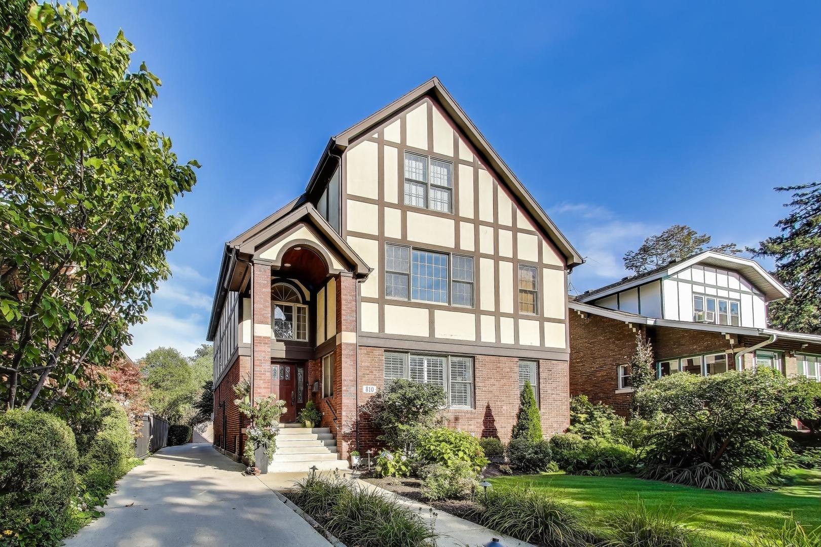 Prime Oak Park location! This impressive Tudor sits on an oversized 53x173 lot with a side drive and 3-car garage. Offering 5 bedrooms, 5.1 baths, and over 5,100 sq. ft. of living space, the home blends timeless character with modern updates. Step into a grand entry with a stunning, height-adjustable chandelier. The formal living room with fireplace flows seamlessly into the dining room. A chef's kitchen features a Wolf range, Sub-Zero refrigerator, Bosch microwave, and large island-perfect for cooking and conversation. Sun-filled family room opens to a spacious (590 sq. ft.)Trek deck (50-year warranty) with a custom 3-season room in progress (permits complete).  Second floor includes 4 bedrooms-two ensuite (including the primary with walk-in closet)-plus a second laundry. The bright third level offers a new bath, walk-in closet/dressing table, and flexible living space, ideal for guests or extended family. Lower level highlights recreational/workout room, a "Costco closet," additional laundry, great storage, and full bath.  Beautifully landscaped grounds feature uplighting, a firepit, and expansive yard for entertaining. Updates include solar panels, 2 new HVAC systems (last 6 yrs), hot water tank, new Bosch microwave, mechanical skylight blinds, all new windows, California Closets, and more. A rare Oak Park offering with space, style, and thoughtful improvements throughout!