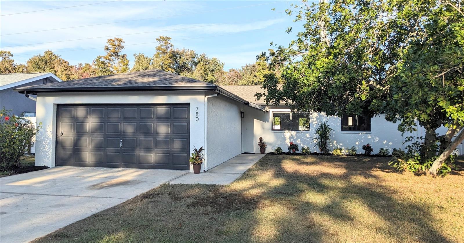 Discover your perfect haven in this stunningly updated 3/2/2-car garage home! "High and dry," it backs onto open space, offering tranquility and no rear neighbors. Move right in—everything is new! The house boasts a brand-new roof, a 2021 A/C unit, and a hot water heater. The kitchen has been transformed into an open-concept dream with shaker cabinets and stainless steel appliances. Bathrooms feature stylish, brand-new tile showers and modern finishes. Enjoy all-new LVP flooring, fresh interior/exterior paint, and new doors, including an impact-rated sliding door.The location can't be beat! Walk to a local park, library, and shops. Commute easily to Tampa (35 min) or relax at nearby destinations: Clearwater Beach (30 min), Tarpon Springs (15 min), and Honeymoon Island (15 min).