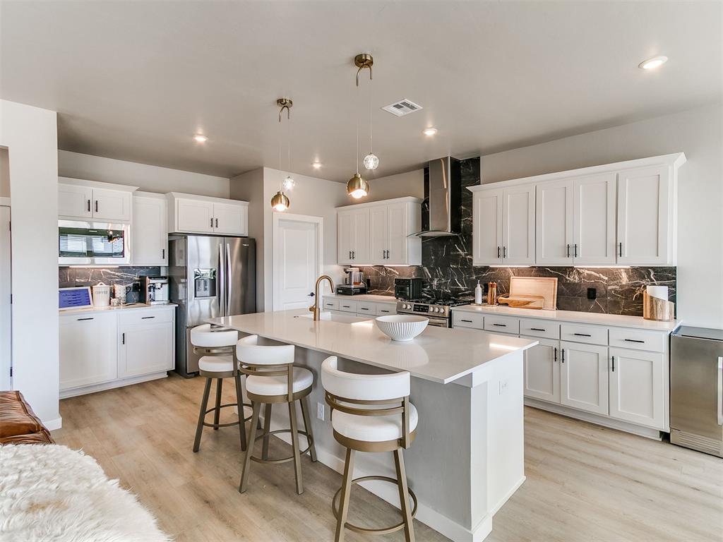 Welcome home to Twin Silos, where modern style meets everyday luxury in the award-winning Deer Creek School District! Situated in a peaceful cul-de-sac on one of the largest lots in the neighborhood at .275 acres, this stunning Malibu floor plan offers exceptional space, comfort, and beautiful updates throughout.This home features 4 bedrooms, 3 full bathrooms, and a downstairs guest half bath, a dedicated office that could also be used as a formal dining room, a spacious upstairs bonus living room, and an expansive backyard—perfect for entertaining or relaxing.Step inside to soaring ceilings and a bright, open layout. The main level has been refreshed with all-new luxury vinyl plank flooring, creating a clean, cohesive feel throughout.The chef’s kitchen shines with quartz countertops, custom cabinetry, stainless steel appliances, a spacious walk-in pantry, abundant storage, and a gas stove, flowing seamlessly into the living room with a cozy fireplace and oversized sliding doors leading to the backyard.Downstairs primary suite is a true retreat, featuring brand-new luxury flooring and a spa-inspired bath with a beautifully updated walk-in shower, dual vanities, a spacious soaking tub, a private water closet, and a large walk-in closet of your dreams.Upstairs offers three additional bedrooms, 2 full bathrooms, a versatile bonus living room, plus all-new carpet upstairs and on the stairs. A functional mudroom with built-in storage provides the perfect drop zone as you enter from the massive 3-car garage, which includes an in-ground storm shelter and a professionally epoxied floor for a polished finish.Enjoy quiet, scenic views from the extended patio, ideal for outdoor gatherings and relaxing evenings. Residents of Twin Silos enjoy neighborhood amenities including a pool, clubhouse, playground, and basketball court, making this community as fun as it is beautiful.Don’t miss this beautifully updated home on an oversized lot. Schedule today!