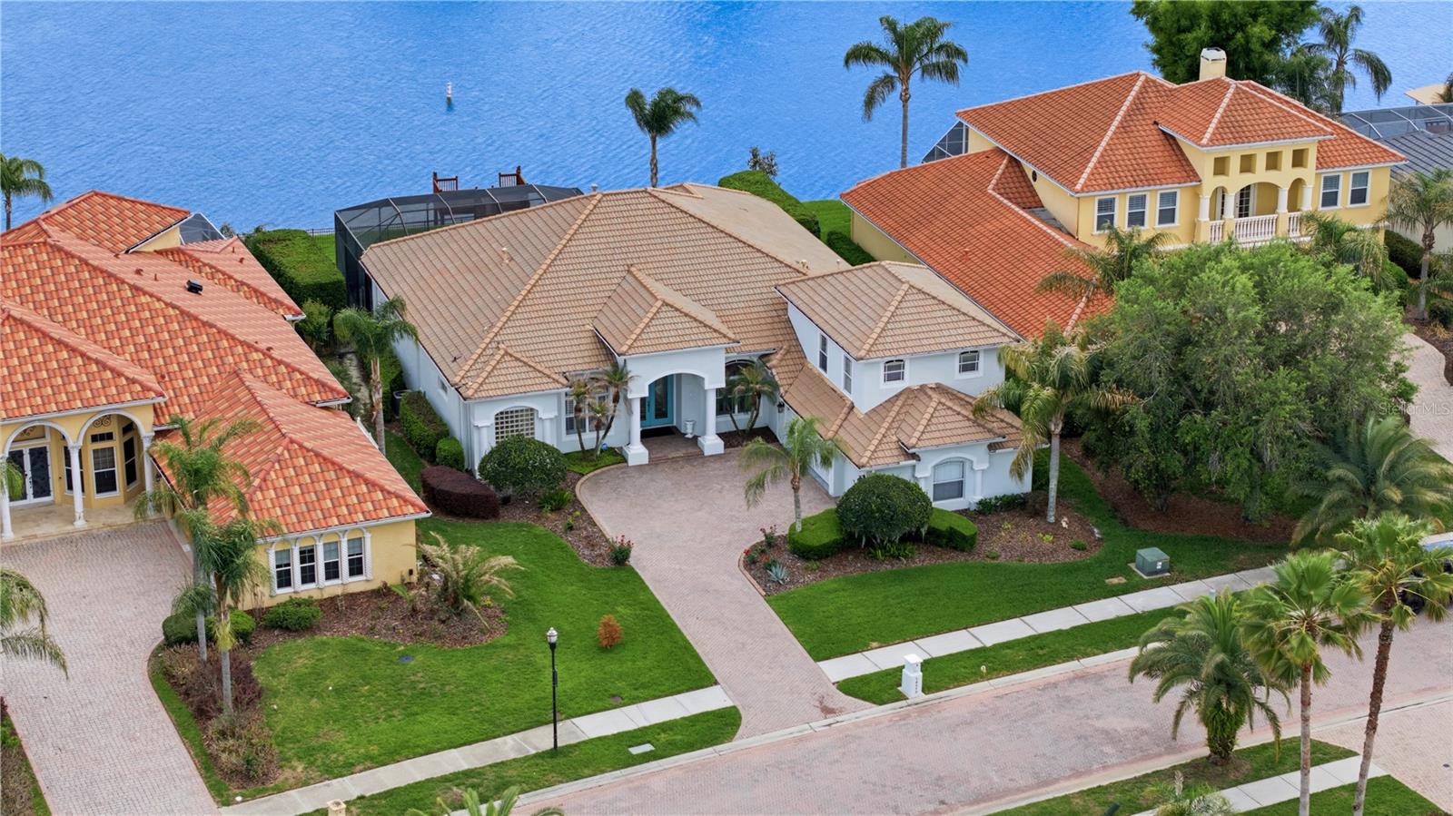 Under contract-accepting backup offers. Nestled on a stunning lakefront lot, 10513 Bermuda Isle in Tampa offers the perfect blend of serene waterfront living and modern upgrades. Imagine starting your mornings with tranquil water views and ending your days with sunsets over the lake, all from the comfort of your own backyard.This spacious home features 4 bedrooms, 3 full baths, and 2 half baths, all conveniently located on the main floor, providing both functionality and flow. Upstairs, you'll find a large bonus room complete with its own half bath, offering endless possibilities—whether it’s a game room, theatre room or guest retreat. One of the standout features of this home is the dedicated office space, designed to inspire productivity and organization. With floor-to-ceiling custom shelving, it’s a dream for book lovers, collectors, or anyone needing ample storage. The 3-car side-entry garage provides ample space for vehicles, storage, or even a workshop, while the durable tile roof adds a touch of timeless elegance and peace of mind.This home has been thoughtfully updated with features designed for both comfort and convenience. Enjoy the efficiency of 3 brand-new HVAC units and 2 new water heaters, plus the energy-saving benefits of blown-in attic insulation rated at R-38. Storage is a breeze with custom closets in every bedroom, while a water softener ensures top-quality water throughout the home. Step outside to your private dock, now upgraded with durable TREX flooring—perfect for fishing, relaxing, or launching a kayak for a peaceful paddle.With its prime location and recent enhancements, this home is ready to elevate your lifestyle. Lakefront living has never looked so effortless!