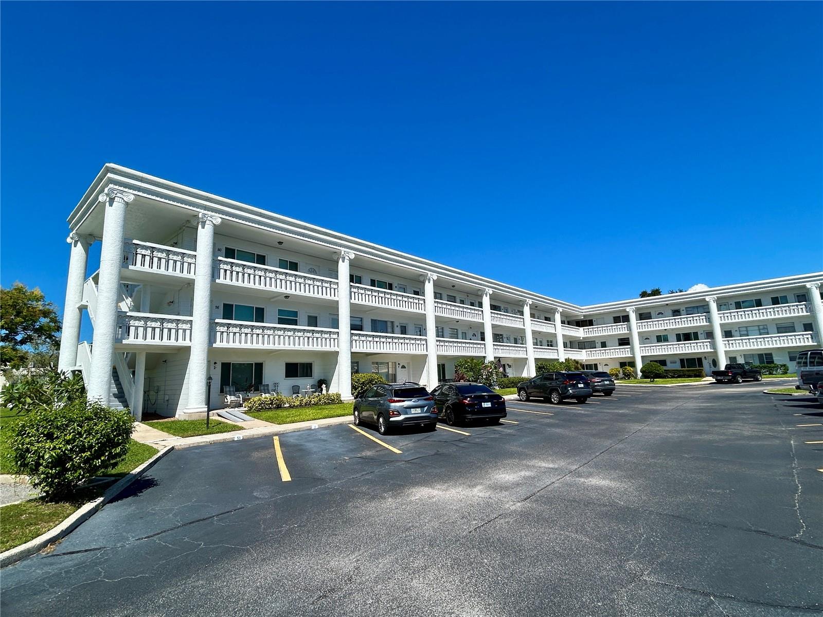 Enjoy the best of Florida living in this ideally located 2-bedroom condo! Just steps from the East Activity Center, you'll have convenient access to swimming pools, a remodeled fitness center, tennis and pickleball courts, and a variety of recreational activities. Inside, laminate flooring extends throughout the living room, dining room, and both bedrooms, creating a cohesive look. The Florida Room features realistic wood-look ceramic tile flooring and a separate doorway providing access to the building's second-floor lobby and laundry facility. The updated kitchen offers slow-close shaker-style cabinets, granite countertops, and ceramic tile flooring. This vibrant 55+ community offers an exceptional array of amenities, including two private golf courses (9- and 18-hole), two heated swimming pools, two activity centers, and a remodeled fitness center equipped with modern exercise equipment. Enjoy an active social calendar featuring fitness classes, dancing, clubs, cards, billiards, and much more. Pet owners will appreciate the fenced dog park with covered seating, while hobby studios and a woodshop offer space to explore creative interests. The on-site Good Karma Café provides convenient hot and cold beverages and snacks. Conveniently located near Gulf Coast beaches, shopping, transportation, entertainment, and fine dining, this fee-simple condo offers an appealing combination of comfort, recreation, and convenience. Don't miss this opportunity to enjoy an active Florida lifestyle in a community filled with amenities! All room sizes, floor plans and square footage are approximate. Association approval is required. If financing, a 35% down payment is required.