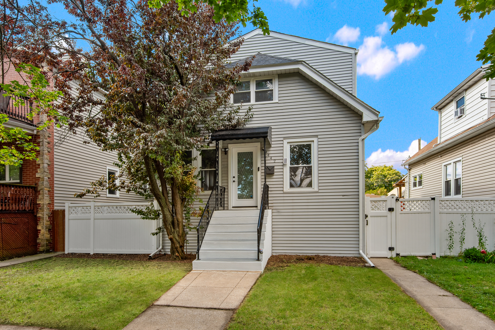 If you're dreaming of a fully renovated home with a massive yard, without leaving the city, look no further! Located on an extra-wide 37' lot on a quiet street in Portage Park, this beautifully updated home offers space, style, and modern updates at every turn. The sun-filled main level features an open-concept living and dining area with gleaming hardwood floors, leading into a stunning chef's kitchen with quartz countertops, herringbone tile backsplash, an oversized island with outlets on both ends, and a walk-in pantry. Let the outdoors in with double glass doors that lead to your 19' x 10' deck, an ideal spot for barbecues, morning coffee, or hosting friends and family. Two spacious bedrooms and a full bath on the main level make ideal guest rooms, in-law space, or offices. Upstairs, the serene primary suite boasts cathedral ceilings with wood beams, skylights, a thoughtfully designed custom walk-in closet, and a spa-like bath with quartz counters, penny tile floors, and an oversized glass shower accented by elegant brass hardware. Another sun-filled bedroom features a skylight, professionally built out closet, and a beautifully renovated full bath with a soaking tub complete the second level. In the basement, you will find a huge laundry room with side-by-side washer/dryer and generous storage space, a family room perfect for movie nights, and an additional space ideal for a home gym, office space, or playroom. This level also features a huge refinished crawl space for added storage. The oversized backyard is fully enclosed with premium 6' white vinyl privacy fencing and includes an elevated patio, a large grassy area with lush mature trees to one side, a custom dog run side-yard complete with river rocks, a detached 2-car garage, and an added concrete carport. Enjoy a 2-car garage with storage potential and the gated carport that could either be used as an extra parking space, a bonfire area, or as the perfect sports court! This backyard oasis offers plenty of opportunity to continue making it your own. With a new roof, skylights, HVAC, washer/dryer, and so much more, this home is completely move-in ready. Prime location near Dunning Square, Ridgemoor Country Club, and multiple parks, including Dunnham Park, which offers a playground, tennis courts, and multiple fields. Commuters will love the easy access to CTA, the Blue Line, the Kennedy Expressway, and ample free street parking. Top-rated schools include Smyser Elementary, Taft High School, and nearby Wright College. This fully renovated home on an oversized lot is truly a rare find!