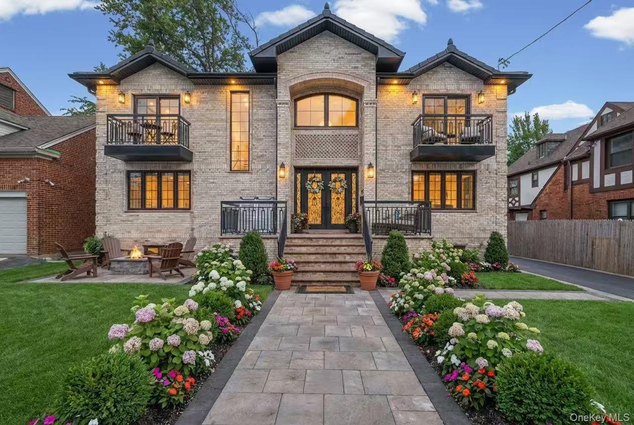 Located in desirable Northern Flushing, this custom-built luxury residence offers rare scale, modern construction and exceptional curb appeal in an area known for classic homes. Featuring a striking symmetrical brick three balconies and professionally landscaped grounds. The first floor offers a grand living room, chef’s kitchen with formal dining area, a first-floor ensuite bedroom and an additional half bath, ideal for guests, live-in help or multigenerational living. The second floor includes a spacious primary suite, an additional ensuite bedroom, two standard bedrooms with a shared full bathroom, and an approx. 200 SF lounge. Additional highlights include an approx. 1,300 SF finished attic with hardwood floors and a 10-foot ceiling finished basement with windows and a full bathroom, ideal for home theater, gym or recreation. Enjoy an oversized patio designed for outdoor dining and lounge living. Imported finishes throughout. Prime Location, 3 Blocks to LIRR Broadway Station, close to Northern Blvd, close to bus stops Q12,Q16,Q28. Walking distance to Bowne Park, schools, shopping, restaurants and supermarkets.