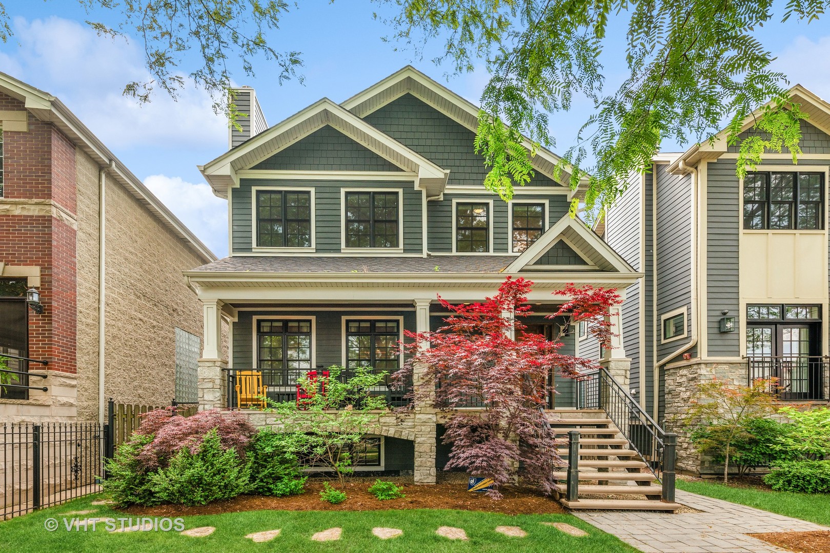 Impeccably built in 2015 by Spain Development, this stunning home sits on a rare oversized 37.5' x 124' lot in the heart of Roscoe Village, within the popular Audubon School district. With over 5,200 sq ft of refined living space across three levels, this home offers high-end finishes, thoughtful design, and unmatched indoor/outdoor living. The exterior features Hardie plank siding with stone accents, a full-width covered front porch, professional landscaping for the expansive front and rear yards, and a rear stone patio with a wood-burning fireplace featuring a full-height stone-chimney. The Hardie board three-car garage features a full-width roof deck with composite decking, electric, and steel stair access. Inside this home, enjoy 9' ceilings t/o, dark-stained oak flooring on two levels, 8" baseboards, crown moldings, Restoration Hardware lighting, and a dramatic three-story oak/wrought iron staircase. The main level offers elegant formal living and dining rooms with coffered and lighted tray ceilings, two wood-burning fireplaces with custom mantels and stone surrounds, a powder room with marble mosaic tile, a large mudroom with hanging space and custom cubbies, and a stunning chef's kitchen with custom lighted cabinetry, quartz counters, a massive island with ample seating, lots of storage, a prep sink and glass globe pendant lighting, high end Sub-Zero, Bosch and Wolf appliances - including a six burner Wolf range with center griddle and three total ovens plus a convection microwave, an organized walk-in pantry, and a causal dining nook with wainscoting. On the second level find a coveted four bedrooms up including a luxurious primary suite with dual custom organized walk-in closets and spa-like marble bath with oversized walk-in shower with steam and hand shower, modern soaking tub with hand shower, radiant heated floors, and custom cabinetry double vanity with inset sconce lighting and full mirror. Two upstairs bedrooms share an upscale Jack & Jill bath with tub shower and double vanity and a third upscale hall bath serves the fourth. A gracious laundry room boasting s/b/s front loading LG washer/dryer, custom cabinets, Quartz counters and utility sink completes the level. The finished lower level includes a very spacious family room for entertaining and play with an elegant, full wall wet bar with dual wine and beverage centers, glass mosaic backsplash and lighted custom cabinetry. In addition, find three lower level bedrooms-including a guest suite with pretty en-suite bath and a bedroom with dual French door access - perfect for an office. A sleek and modern hall bath with glass standing shower, a secondary laundry room completes the floor and a rear staircase provide convenient access to the outdoors. Modern systems include dual-zone HVAC, radiant floor heating (interior + exterior), Nest thermostats, 200-amp electric, ORBI whole-house WiFi, SANUS/SONOS audio system, and security system with cameras and motion. All this in an unbeatable location right across from Audubon, and steps from shops, dining, parks, and public transportation. This rare opportunity for indoor and outdoor space, quality construction, and classic style lives in one of Chicago's most desirable neighborhoods. NOTE: Home sold in AS-IS condition. See disclosures for additional information.