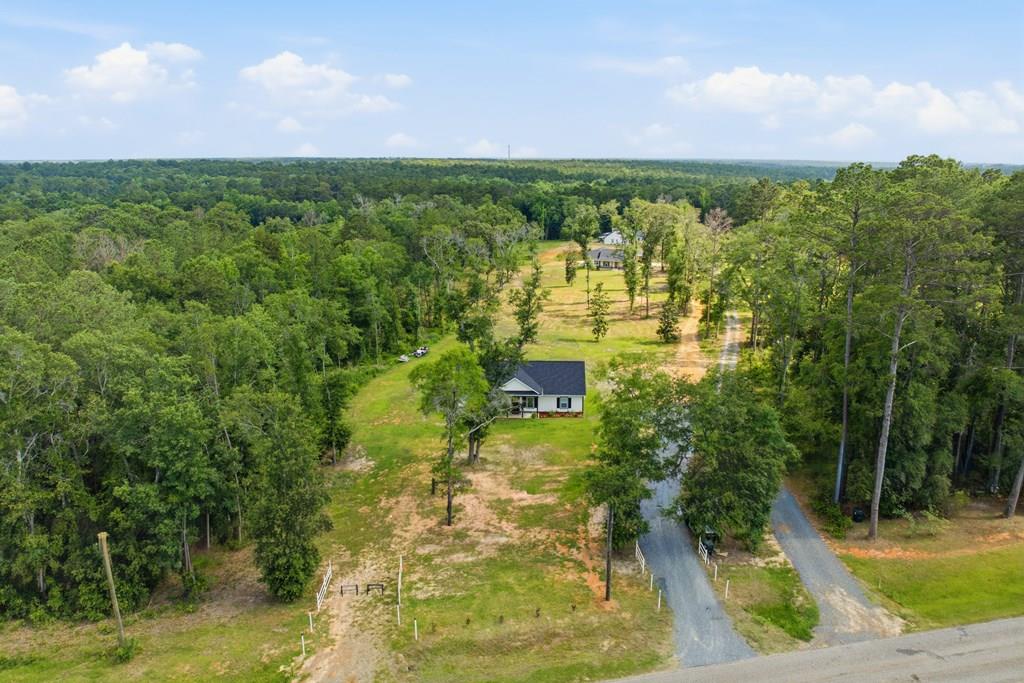 New Construction on 2.05 Acres with the Option for 3.05 Acres! This beautiful custom-built 3-bedroom, 2-bath home is located off Meridian Road across from Rosemary Plantation in Southern Georgia. Offering the perfect blend of privacy and convenience, it's an ideal choice for those commuting to Tallahassee while enjoying the tranquility of country living. A welcoming rocking-chair front porch invites you into the spacious living and great room, designed for both comfortable everyday living and entertaining. The thoughtfully appointed kitchen features granite countertops, custom cabinetry, stainless steel appliances, a generous walk-in pantry, and a large island with seating. Luxury vinyl plank flooring flows throughout the home, offering both style and durability. The spacious primary suite includes a walk-in closet and a beautifully appointed vanity area accented with marble and tile finishes. The split-bedroom floor plan provides added privacy, with two additional bedrooms and a full bath situated on the opposite side of the home. The property is offered with approximately 2.05 acres, with the option to purchase an additional adjoining acre for a total of 3.05 acres, providing additional privacy and room to grow. Carport plans are also available for the new owner.