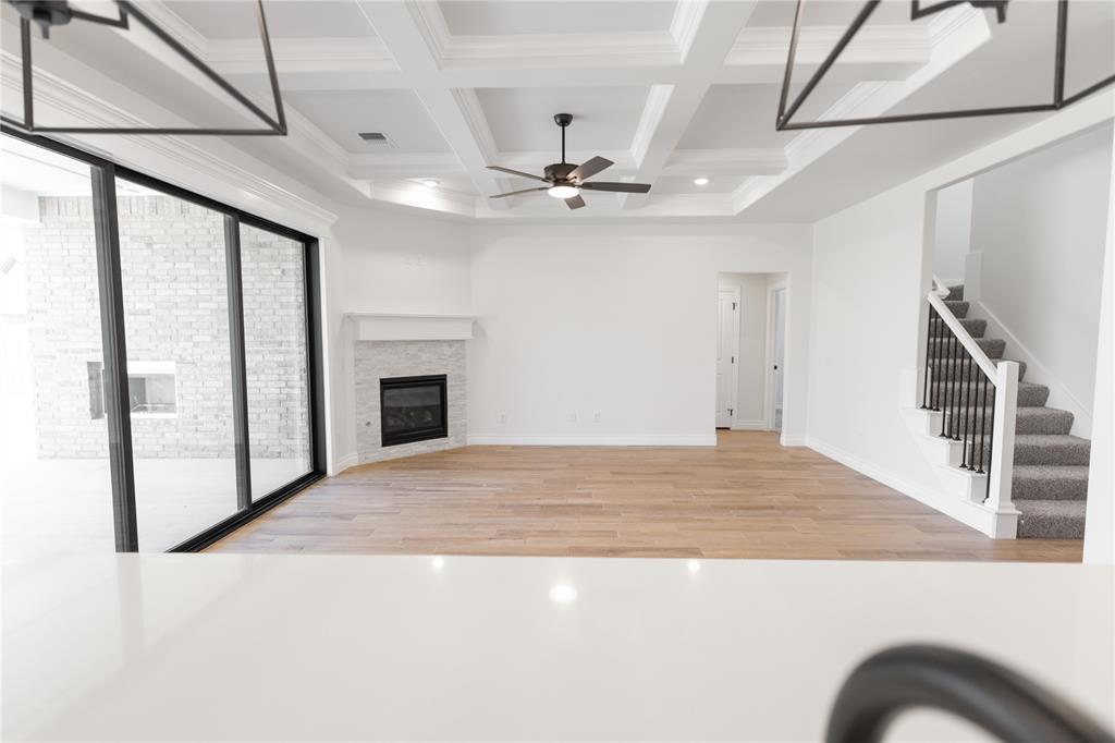 This Hazel Bonus Room 5 Bedroom has 2,735 Sqft of total living space, which includes 2,520 Sqft of indoor living space and 215 Sqft of outdoor living space. This two-story luxury home offers 5 bedrooms, 3 full baths, 2 covered patios, a spacious bonus room, a large utility room featuring a utility sink, and a 3-car garage with an in-ground storm shelter installed. The living room presents a stacked stone corner gas fireplace, a 3-panel sliding door with a 4’ back patio extension, wood-look tile, Cat6 wiring, rocker switches throughout, and an impeccable coffered ceiling with a ceiling fan and crown molding. The kitchen supports stainless steel appliances, including a 5-burner cooktop and double ovens, custom-built cabinets to the ceiling with glass and lights in the uppers, cabinet hardware throughout, 3 CM countertops, stunning pendant lighting, a large corner pantry, modern tile backsplash, and an oversized island with a built-in trash can pullout. The primary suite offers a sloped ceiling with a ceiling fan, windows, and our cozy carpet finish. The prime bath features a dual sink vanity with framed mirrors, a free-standing tub, a walk-in shower, a private water closet, and a HUGE walk-in closet. Covered outdoor living boasts a wood-burning fireplace, a gas line for your grill, and a TV hookup for your flatscreen. This home also offers our healthy home technology, a tankless water heater, a whole home air filtration system, R-44 insulation, and more!