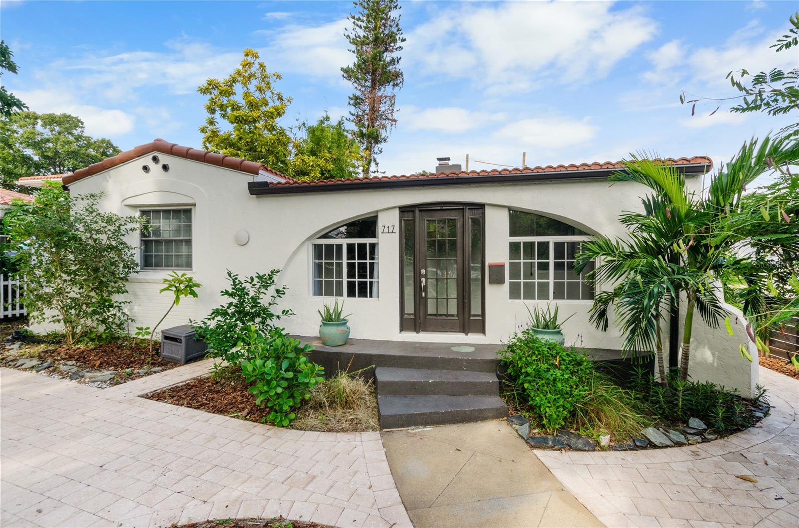 Step into timeless charm just steps from Crescent Lake Park. Located in a desirable non-flood zone, this beautifully maintained 1930s Spanish-style home offers 4 bedrooms, 3 baths, and over 2,000 heated square feet of character, updates, and flexible living space- all just minutes from vibrant downtown St. Petersburg and I-275.Perched slightly above the street and only one house in from the 56-acre Crescent Lake Park, the home enjoys serene lake views from its inviting enclosed front porch. Natural stone flooring and arched windows create the perfect spot for morning coffee or sunset unwinding.Inside, the stunning vaulted living room showcases original architectural drama with cathedral wood-beamed ceilings, a wood-burning fireplace, and inlaid hardwood and parquet floors. The spacious dining room sits just beyond and flows into the updated kitchen, complete with a charming arched entryway and newer stainless steel appliances including a gas range. Off the kitchen, a step-down family room/guest suite offers ideal flexibility with its own seating area, bedroom, and bathroom.Thoughtful updates ensure comfort and peace of mind while preserving the home’s historic character to include: tile roof (2021), new HVAC duct system (2021), updated wiring & panel box (2019), zoned central heat & air (2015), newer windows, efficient tankless water heater, newer kitchen appliances, washer and dryer. The property also features a private driveway, a deep single-car garage, cozy front porch, mature Florida-friendly landscaping, fenced yard, and attractive shellock pavers.Just 50 yards from Crescent Lake’s walking paths, playground, dog park, tennis courts, and pickleball courts, and a short walk or bike ride to Trader Joe’s, Rollin’ Oats, and an array of local restaurants and shops, you truly cannot beat this location.A rare blend of historic charm, modern updates, and one of St. Pete’s most treasured neighborhoods, this Spanish-style beauty is ready to welcome you home.